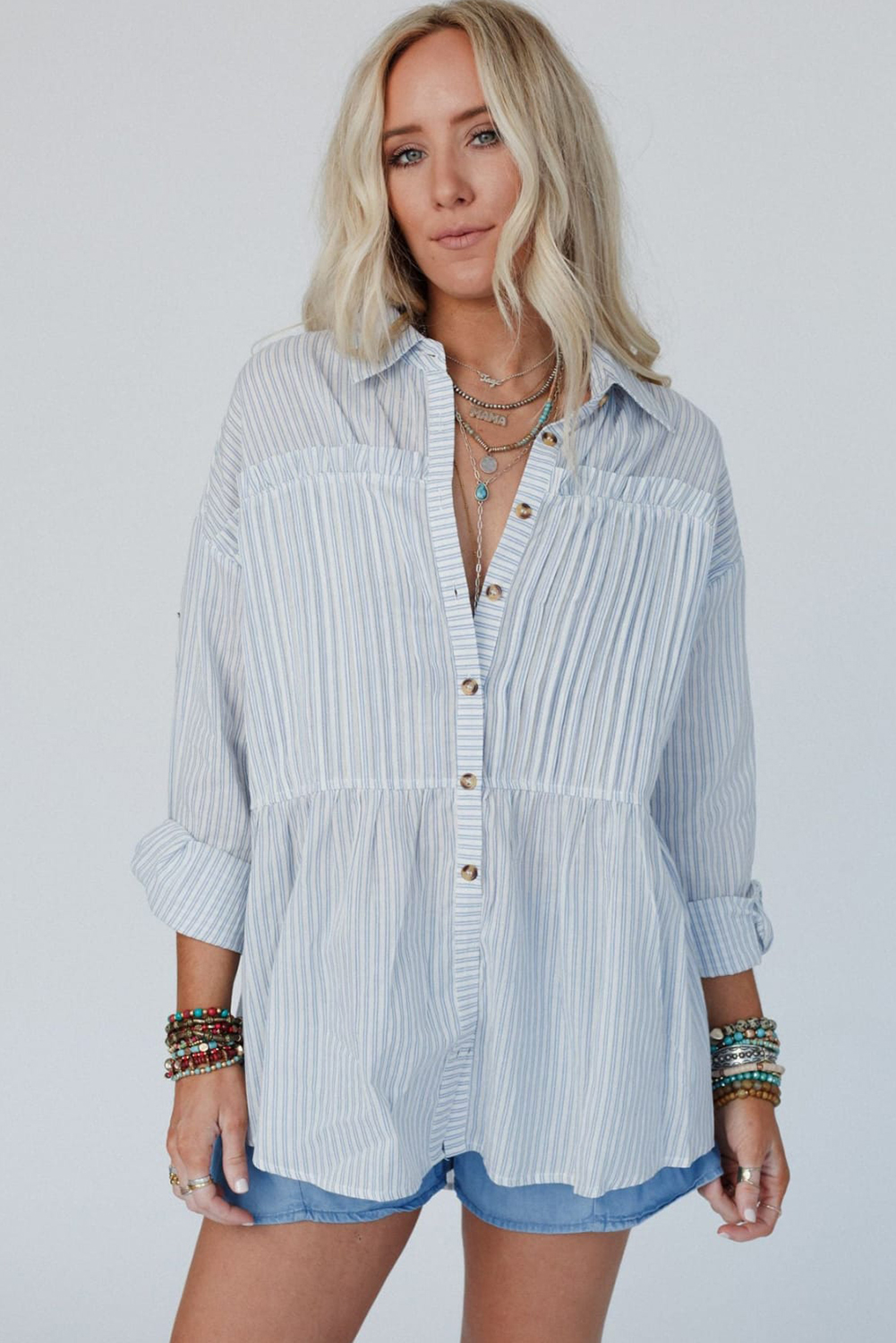 Elevate your style with this Women's Sky Blue Stripe Long Sleeve Button-Up Shirt. The classic striped design offers a timeless and polished look, perfect for various occasions. The button-up style adds versatility and a touch of refinement to your outfit. Featuring long sleeves, this shirt exudes a sophisticated and elegant feel, making it ideal for daily wear. The turn-down collar adds an extra touch of refinement, enhancing the overall look of the shirt. Made from premium 100% cotton, this shirt ensures both comfort and durability. The sky blue stripe pattern adds a pop of color and interest to your ensemble. Catering to various body types and sizes, this shirt is designed to provide a flattering and comfortable fit for all. Add this versatile and stylish shirt to your wardrobe for a timeless and chic look. - Detail View 4 Elevate your style with this Women's Sky Blue Stripe Long Sleeve Button-Up Shirt. The classic striped design offers a timeless and polished look, perfect for various occasions. The button-up style adds versatility and a touch of refinement to your outfit. Featuring long sleeves, this shirt exudes a sophisticated and elegant feel, making it ideal for daily wear. The turn-down collar adds an extra touch of refinement, enhancing the overall look of the shirt. Made from premium 100% cotton, this shirt ensures both comfort and durability. The sky blue stripe pattern adds a pop of color and interest to your ensemble. Catering to various body types and sizes, this shirt is designed to provide a flattering and comfortable fit for all. Add this versatile and stylish shirt to your wardrobe for a timeless and chic look. - Detail View 4