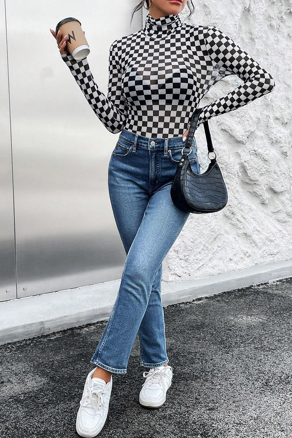 Make a statement with this bold and timeless black checkered bodysuit, featuring long sleeves for added warmth and a sophisticated high neck design. The sleek and slim fit silhouette ensures a flattering and feminine look, perfect for both casual and dressy occasions. The 95% polyester and 5% elastane material ensures durability and comfort, while the checkered print adds a touch of elegance to your outfit. Pair it with your favorite skirt or pants for a chic and stylish look. This bodysuit is a must-have for your wardrobe update, offering versatile styles for any occasion. - Detail View 4 Make a statement with this bold and timeless black checkered bodysuit, featuring long sleeves for added warmth and a sophisticated high neck design. The sleek and slim fit silhouette ensures a flattering and feminine look, perfect for both casual and dressy occasions. The 95% polyester and 5% elastane material ensures durability and comfort, while the checkered print adds a touch of elegance to your outfit. Pair it with your favorite skirt or pants for a chic and stylish look. This bodysuit is a must-have for your wardrobe update, offering versatile styles for any occasion. - Detail View 4