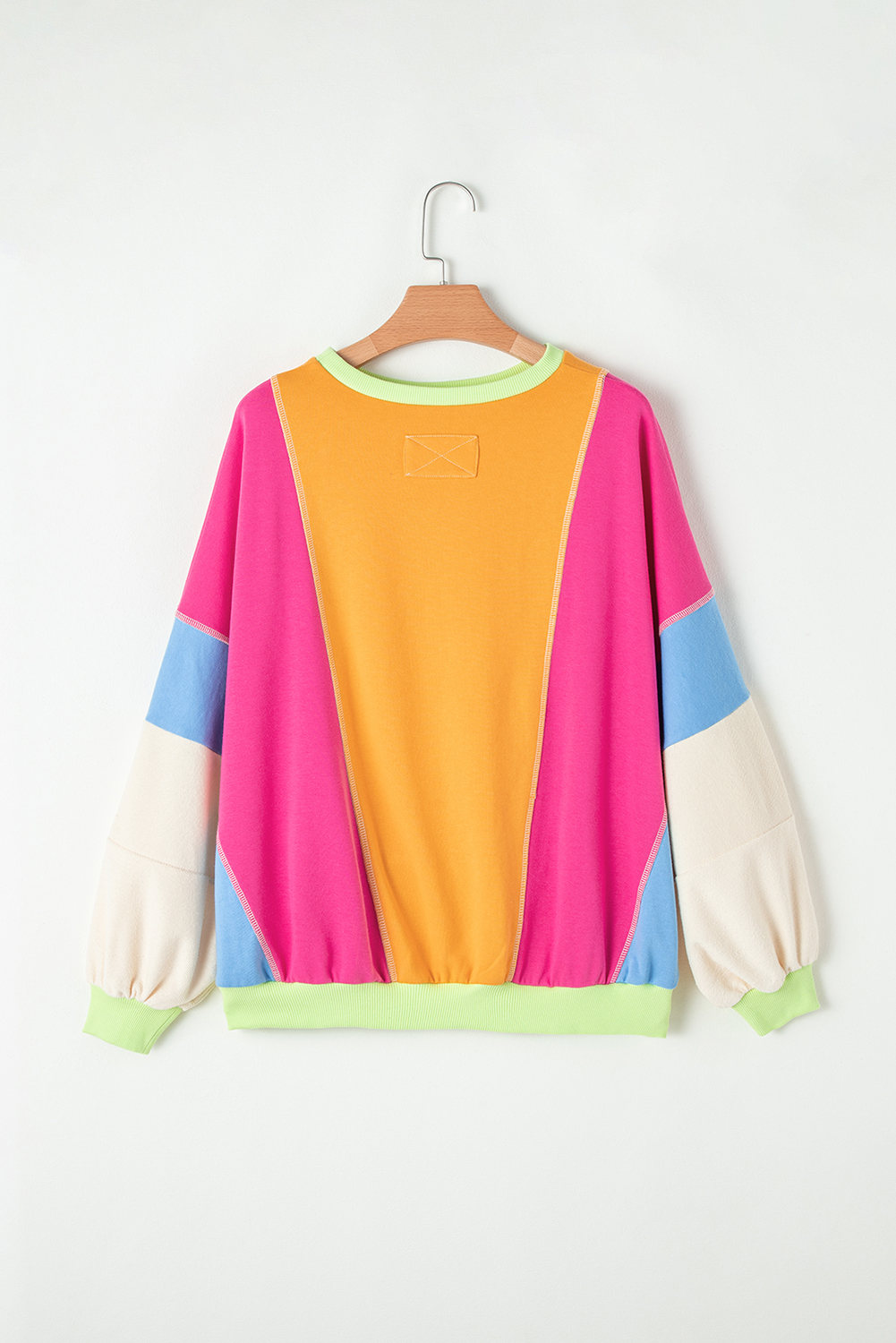 Make a statement on the street with this Women's Grapefruit Orange Colorblock Patchwork Oversize Top. The oversize fit is flattering for most body shapes and ensures a comfortable and trendy look. The popular color block design adds a touch of modernity and will never go out of style. Made from a blend of 65% polyester and 35% cotton, this pullover top is suitable for both autumn and winter dressing, providing warmth and style. The long sleeves make it perfect for the cooler seasons, while the round neck adds a casual and chic element to the top. This versatile top is ideal for daily wear, offering a fashionable and comfortable option for a variety of occasions. Stand out from the crowd with this unique and competitively priced top. - Detail View 4 Make a statement on the street with this Women's Grapefruit Orange Colorblock Patchwork Oversize Top. The oversize fit is flattering for most body shapes and ensures a comfortable and trendy look. The popular color block design adds a touch of modernity and will never go out of style. Made from a blend of 65% polyester and 35% cotton, this pullover top is suitable for both autumn and winter dressing, providing warmth and style. The long sleeves make it perfect for the cooler seasons, while the round neck adds a casual and chic element to the top. This versatile top is ideal for daily wear, offering a fashionable and comfortable option for a variety of occasions. Stand out from the crowd with this unique and competitively priced top. - Detail View 4