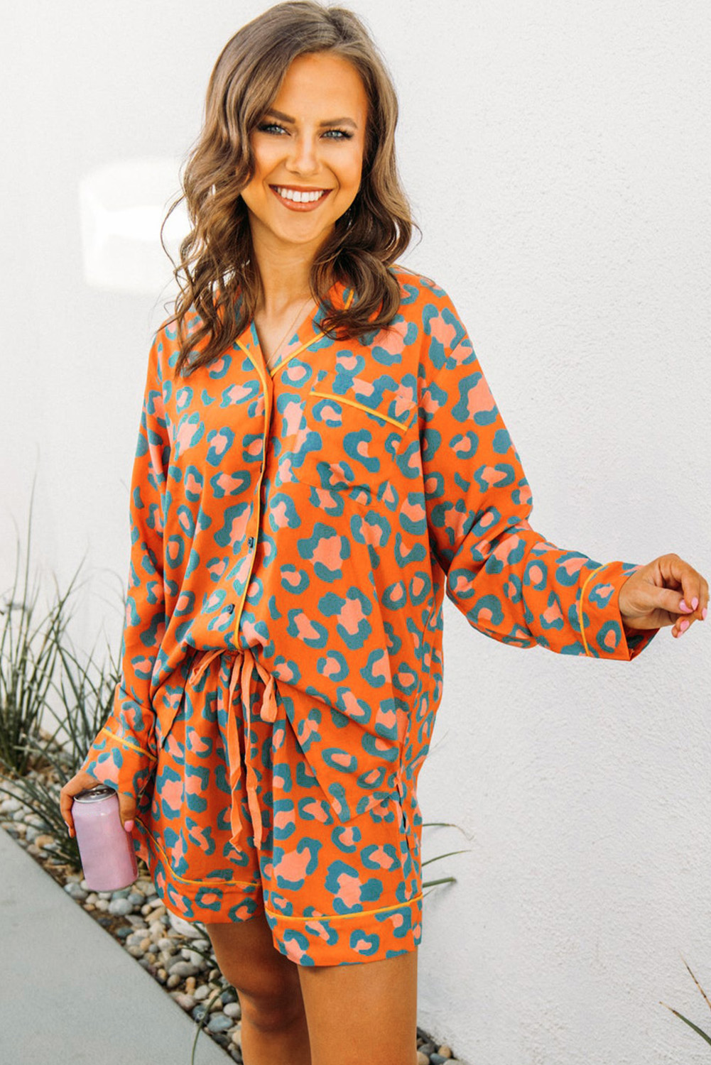 Indulge in the comfort and style of this unique leopard print pajama set. The long sleeve shirt and drawstring waist shorts feature an all-over print design, crafted from soft 100% viscose material for an exceptional night's sleep. With a relaxed fit and high-waist design, this set is perfect for lounging at home or a fun sleepover with friends. The iconic leopard print adds a touch of wild elegance, allowing you to unleash your inner fashionista. Pair with your favorite slippers for a cozy and intimate night in. - Detail View 4 Indulge in the comfort and style of this unique leopard print pajama set. The long sleeve shirt and drawstring waist shorts feature an all-over print design, crafted from soft 100% viscose material for an exceptional night's sleep. With a relaxed fit and high-waist design, this set is perfect for lounging at home or a fun sleepover with friends. The iconic leopard print adds a touch of wild elegance, allowing you to unleash your inner fashionista. Pair with your favorite slippers for a cozy and intimate night in. - Detail View 4
