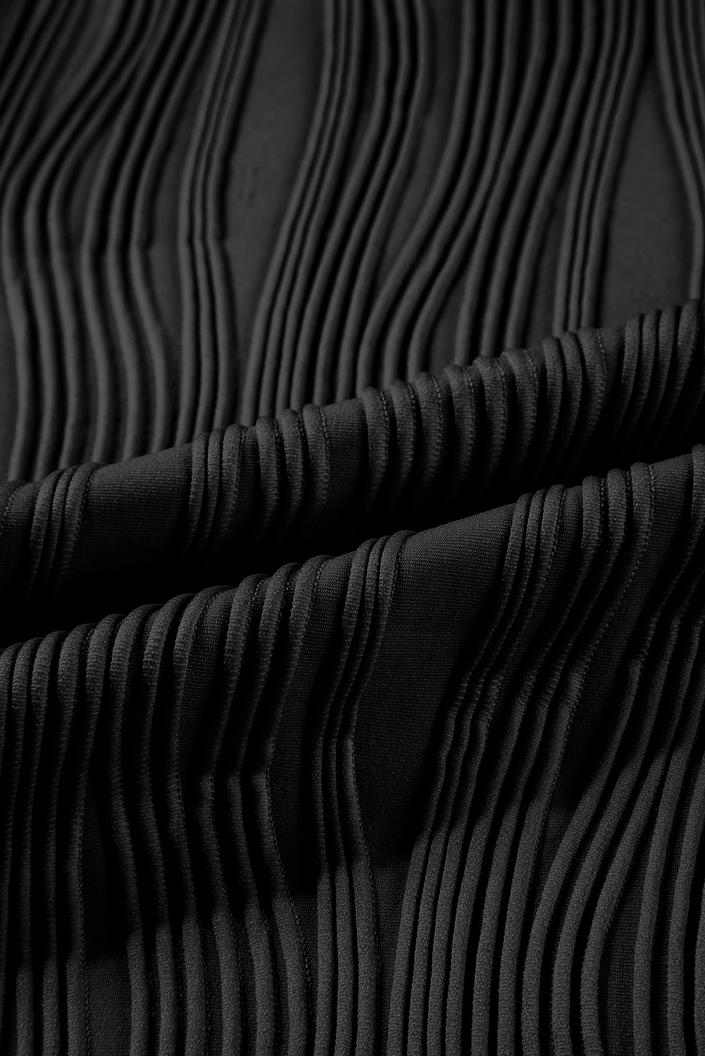 Elevate your casual wardrobe with this Women's Black Textured Wavy Round Neck Long Sleeve Top. The intricate wavy fabric texture adds a distinctive and tactile appeal to the classic round neck design, making it a timeless addition to your collection. Made from a premium blend of 91% polyester and 9% elastane, this top offers both comfort and durability. The solid black color and concise style make it versatile to style, pairing well with any fashionable jeans and pants. This elegant long sleeve top is perfect for daily wear and can easily transition from day to night. Its modern and sophisticated silhouette adds a touch of chic to any outfit, making it a must-have for the winter season. - Detail View 9 Elevate your casual wardrobe with this Women's Black Textured Wavy Round Neck Long Sleeve Top. The intricate wavy fabric texture adds a distinctive and tactile appeal to the classic round neck design, making it a timeless addition to your collection. Made from a premium blend of 91% polyester and 9% elastane, this top offers both comfort and durability. The solid black color and concise style make it versatile to style, pairing well with any fashionable jeans and pants. This elegant long sleeve top is perfect for daily wear and can easily transition from day to night. Its modern and sophisticated silhouette adds a touch of chic to any outfit, making it a must-have for the winter season. - Detail View 9