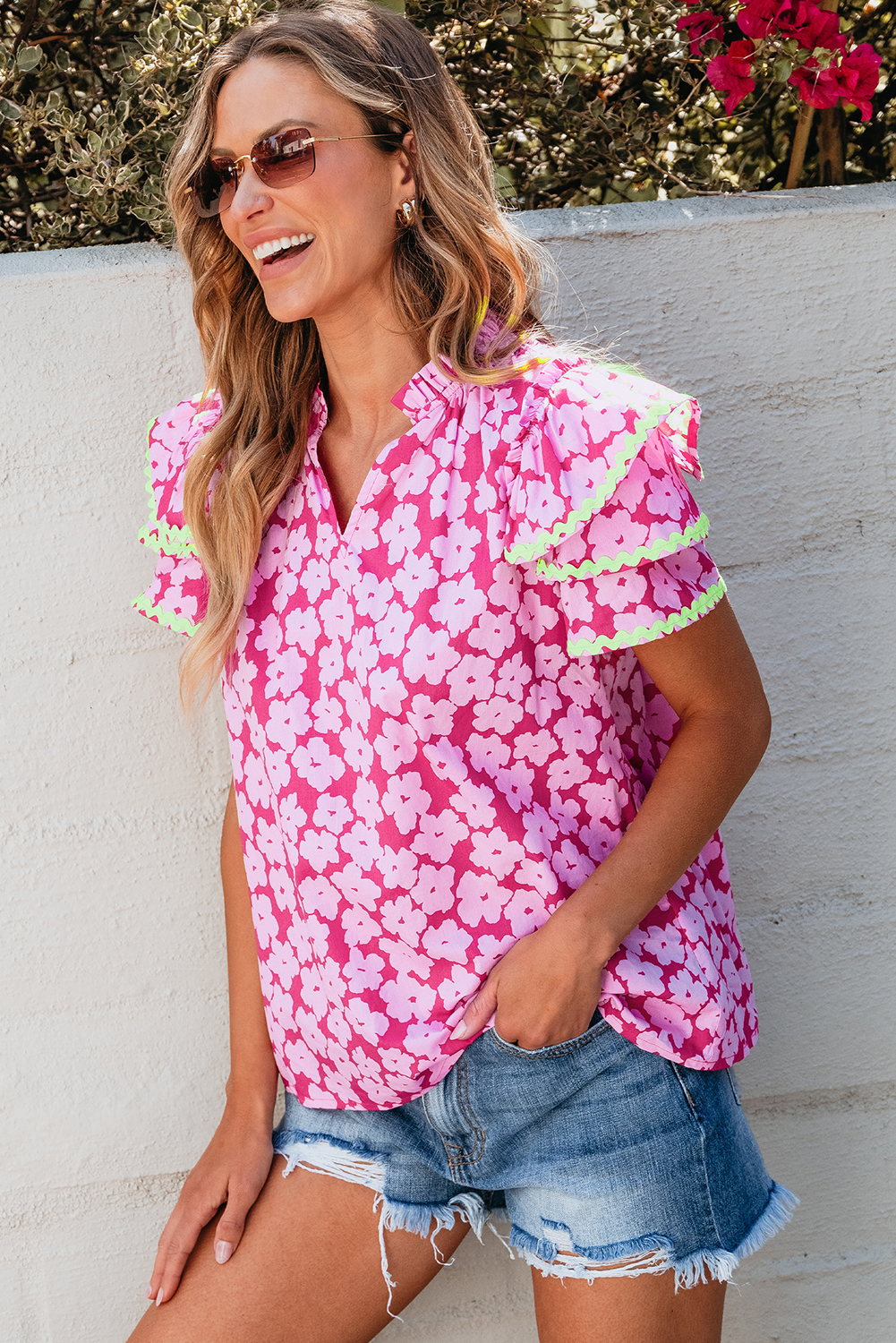 Make a fashion statement with this Women's Pink Floral Contrast Ric Rac Layered Ruffle Sleeve Blouse. The floral print and tiered ruffle sleeve design add a touch of charm and femininity to this stunning blouse. The contrast ric rac trim adds intricate detail, making this blouse delicate and unique. Made from premium 100% cotton, this blouse is not only gorgeous and appealing but also ensures comfort and breathability. The exclusive floral pattern makes it suitable for both casual and dressy occasions, allowing you to stand out in style. The V-neck and short sleeves enhance the elegant and chic look of the blouse, making it a versatile and must-have piece for your wardrobe. Pair it with your favorite jeans or a skirt to create a chic and trendy ensemble. Embrace your unique style with this stylish and elegant blouse. - Detail View 4 Make a fashion statement with this Women's Pink Floral Contrast Ric Rac Layered Ruffle Sleeve Blouse. The floral print and tiered ruffle sleeve design add a touch of charm and femininity to this stunning blouse. The contrast ric rac trim adds intricate detail, making this blouse delicate and unique. Made from premium 100% cotton, this blouse is not only gorgeous and appealing but also ensures comfort and breathability. The exclusive floral pattern makes it suitable for both casual and dressy occasions, allowing you to stand out in style. The V-neck and short sleeves enhance the elegant and chic look of the blouse, making it a versatile and must-have piece for your wardrobe. Pair it with your favorite jeans or a skirt to create a chic and trendy ensemble. Embrace your unique style with this stylish and elegant blouse. - Detail View 4