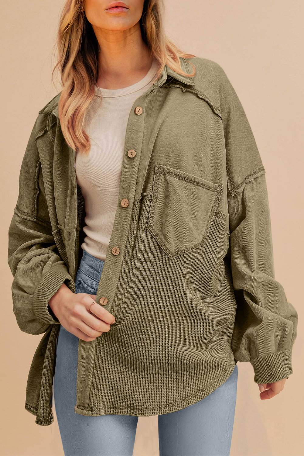 Stay stylish and warm this fall and autumn with this oversized Moss Green Patchwork Buttoned Waffle Knit Shacket. The waffle knit fabric adds a textured look and feel, while the patchwork design gives the shacket a unique and eye-catching touch. A chest pocket provides both functionality and a classic aesthetic. This casual shacket is perfect for daily wear, and its oversized fit makes it a great layering piece. Pair it with jeans and sneakers for a relaxed look or dress it up with a skirt and leggings for a more polished ensemble. With its warm and cozy design, this shacket is a must-have for any woman's wardrobe. - Detail View 4 Stay stylish and warm this fall and autumn with this oversized Moss Green Patchwork Buttoned Waffle Knit Shacket. The waffle knit fabric adds a textured look and feel, while the patchwork design gives the shacket a unique and eye-catching touch. A chest pocket provides both functionality and a classic aesthetic. This casual shacket is perfect for daily wear, and its oversized fit makes it a great layering piece. Pair it with jeans and sneakers for a relaxed look or dress it up with a skirt and leggings for a more polished ensemble. With its warm and cozy design, this shacket is a must-have for any woman's wardrobe. - Detail View 4