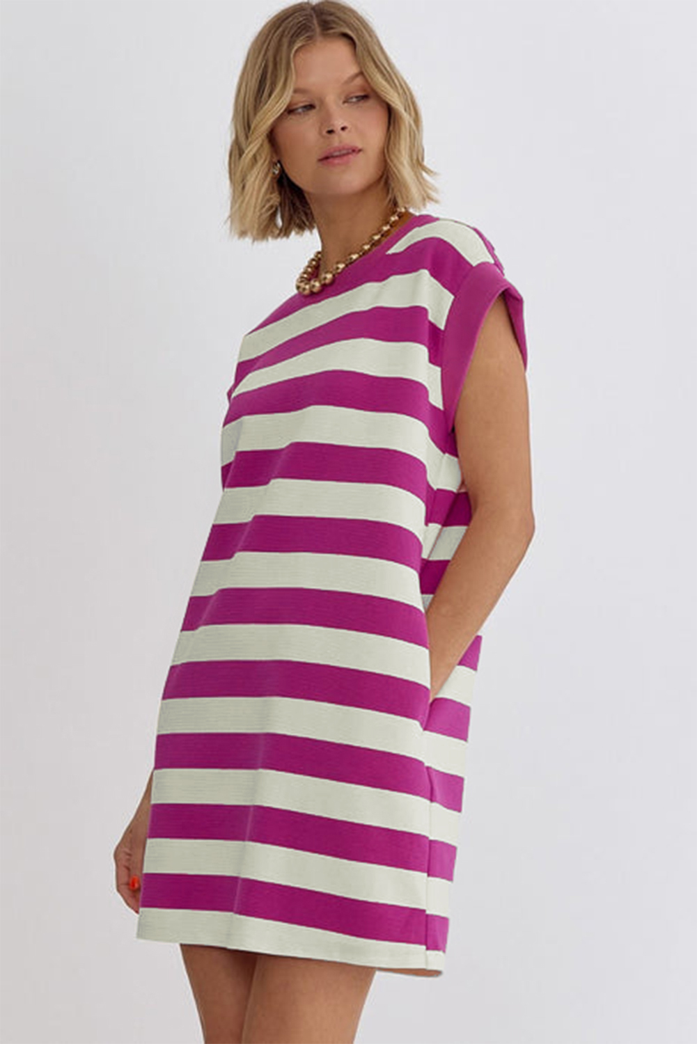 Elevate your casual wardrobe with this Women's Rose Stripe Cap Sleeve Pocketed Shift T-shirt Dress. This fashion-forward dress features a round neck, cap sleeves, and a mini length, offering a simple yet stylish look for women of all ages. The casual t-shirt style is designed with convenient side pockets, adding a practical and trendy touch to the dress. Made from a blend of 58% polyester, 30% cotton, 10% viscose, and 2% elastane, this dress ensures comfort and durability. The pink striped pattern adds a playful and chic element to the design, making it suitable for daily fashion looks. Pair it with sneakers for a laid-back and effortlessly cool ensemble. This t-shirt dress is a versatile and must-have addition to your summer wardrobe, suitable for various casual occasions. - Detail View 9 Elevate your casual wardrobe with this Women's Rose Stripe Cap Sleeve Pocketed Shift T-shirt Dress. This fashion-forward dress features a round neck, cap sleeves, and a mini length, offering a simple yet stylish look for women of all ages. The casual t-shirt style is designed with convenient side pockets, adding a practical and trendy touch to the dress. Made from a blend of 58% polyester, 30% cotton, 10% viscose, and 2% elastane, this dress ensures comfort and durability. The pink striped pattern adds a playful and chic element to the design, making it suitable for daily fashion looks. Pair it with sneakers for a laid-back and effortlessly cool ensemble. This t-shirt dress is a versatile and must-have addition to your summer wardrobe, suitable for various casual occasions. - Detail View 9