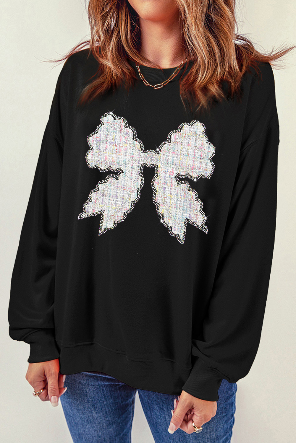 Add a touch of elegance to your casual wardrobe with this Women's Black Rhinestone Decor Bowknot Graphic Pullover Sweatshirt. The pullover style ensures a comfortable and easy wear, while the rhinestone decorations on the bowknot graphic add a touch of sparkle. This stylish and cozy sweatshirt is perfect for daily wear, layering or wearing on its own. The round neck and long sleeve design provides a comfortable fit. Pair it with jeans or casual pants for a fashionable ensemble. Whether you're lounging around or running errands, this graphic sweatshirt is sure to keep you looking and feeling great. - Detail View 4 Add a touch of elegance to your casual wardrobe with this Women's Black Rhinestone Decor Bowknot Graphic Pullover Sweatshirt. The pullover style ensures a comfortable and easy wear, while the rhinestone decorations on the bowknot graphic add a touch of sparkle. This stylish and cozy sweatshirt is perfect for daily wear, layering or wearing on its own. The round neck and long sleeve design provides a comfortable fit. Pair it with jeans or casual pants for a fashionable ensemble. Whether you're lounging around or running errands, this graphic sweatshirt is sure to keep you looking and feeling great. - Detail View 4