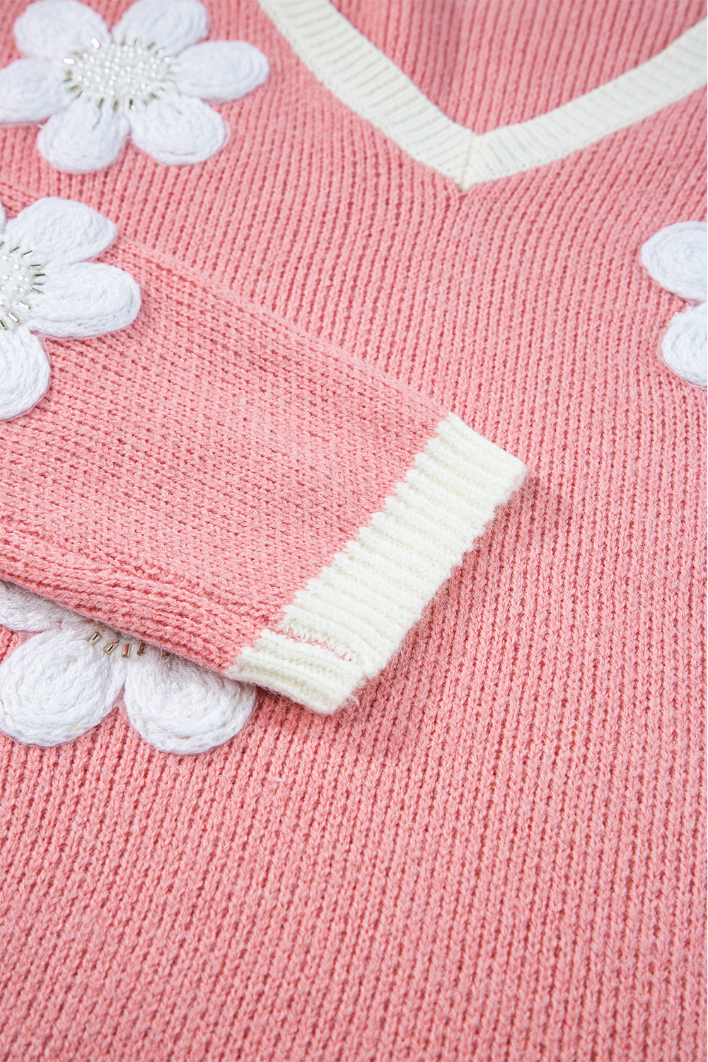 Enchant with the delicate and charming Women's Pink Floral V Neck Dropped Shoulder Sweater. This sweater exudes elegance with its floral design, making it suitable for both casual and dressy occasions. The flattering V neck and relaxed dropped shoulder offer a stylish and comfortable fit. Add a touch of femininity to your wardrobe with this cozy and chic sweater, perfect for adding warmth and flair to your fall ensemble. Made from a premium blend of 60% acrylic and 40% polyamide, this sweater ensures durability and softness against the skin. The long sleeves provide extra warmth, while the pink flower print adds a pop of color and charm. Pair it with your favorite jeans or leggings for a stylish and cozy look. Elevate your style with this elegant and versatile sweater. - Detail View 9 Enchant with the delicate and charming Women's Pink Floral V Neck Dropped Shoulder Sweater. This sweater exudes elegance with its floral design, making it suitable for both casual and dressy occasions. The flattering V neck and relaxed dropped shoulder offer a stylish and comfortable fit. Add a touch of femininity to your wardrobe with this cozy and chic sweater, perfect for adding warmth and flair to your fall ensemble. Made from a premium blend of 60% acrylic and 40% polyamide, this sweater ensures durability and softness against the skin. The long sleeves provide extra warmth, while the pink flower print adds a pop of color and charm. Pair it with your favorite jeans or leggings for a stylish and cozy look. Elevate your style with this elegant and versatile sweater. - Detail View 9