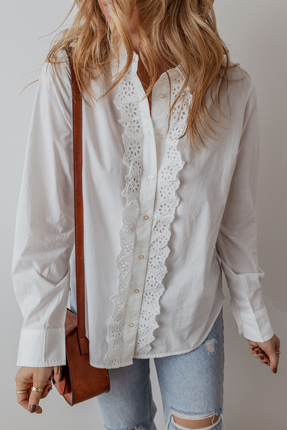 Elevate your style with this beautiful Women's White Lace Crochet Trim Long Sleeve Shirt with Turn-Down Collar. The delicate lace crochet trim adds a touch of sophistication, while the classic turn-down collar provides a polished and professional appearance. The buttoned front makes it easy to wear, and the traditional timeless style ensures it's perfect for both casual and semi-formal occasions. Designed with a comfortable fit, this shirt is a fashionable choice that combines sophistication with comfort. Made from 100% cotton, it's breathable and durable. The white solid color makes it easy to pair with anything, from jeans to trousers. This shirt is a must-have addition to your wardrobe, perfect for any occasion. - Detail View 4 Elevate your style with this beautiful Women's White Lace Crochet Trim Long Sleeve Shirt with Turn-Down Collar. The delicate lace crochet trim adds a touch of sophistication, while the classic turn-down collar provides a polished and professional appearance. The buttoned front makes it easy to wear, and the traditional timeless style ensures it's perfect for both casual and semi-formal occasions. Designed with a comfortable fit, this shirt is a fashionable choice that combines sophistication with comfort. Made from 100% cotton, it's breathable and durable. The white solid color makes it easy to pair with anything, from jeans to trousers. This shirt is a must-have addition to your wardrobe, perfect for any occasion. - Detail View 4