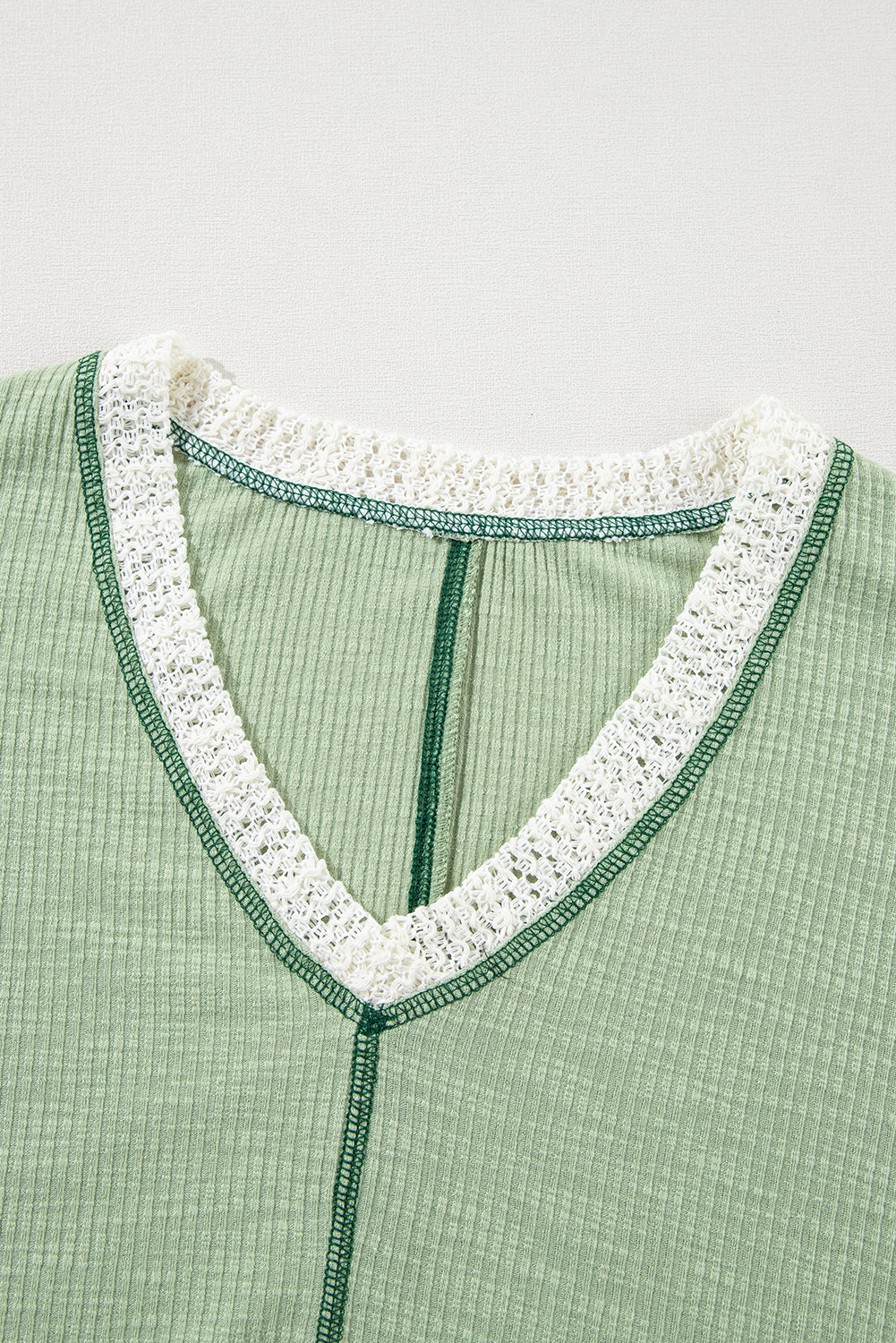 Elevate your wardrobe with this trendy and feminine Women's Grass Green Exposed Seam High Low Loose Fit Crochet Top. Designed in a relaxed fit for a slouchy touch, this knit top features a stylish and vintage appeal with exposed seam and raw hemline. The intricate crochet detail and high low design add a touch of elegance, making it perfect for any body shape to look flattering. This top is friendly and versatile, suitable for daily wear from spring to winter styles. Made from a blend of 60% polyester, 35% cotton, and 5% elastane, this top ensures comfort and softness. Pair it with distressed denim jeans for a chic and causal look, or with a flowy skirt for a more feminine ensemble. This top is a must-have for any woman's wardrobe, offering both style and comfort. - Detail View 9 Elevate your wardrobe with this trendy and feminine Women's Grass Green Exposed Seam High Low Loose Fit Crochet Top. Designed in a relaxed fit for a slouchy touch, this knit top features a stylish and vintage appeal with exposed seam and raw hemline. The intricate crochet detail and high low design add a touch of elegance, making it perfect for any body shape to look flattering. This top is friendly and versatile, suitable for daily wear from spring to winter styles. Made from a blend of 60% polyester, 35% cotton, and 5% elastane, this top ensures comfort and softness. Pair it with distressed denim jeans for a chic and causal look, or with a flowy skirt for a more feminine ensemble. This top is a must-have for any woman's wardrobe, offering both style and comfort. - Detail View 9
