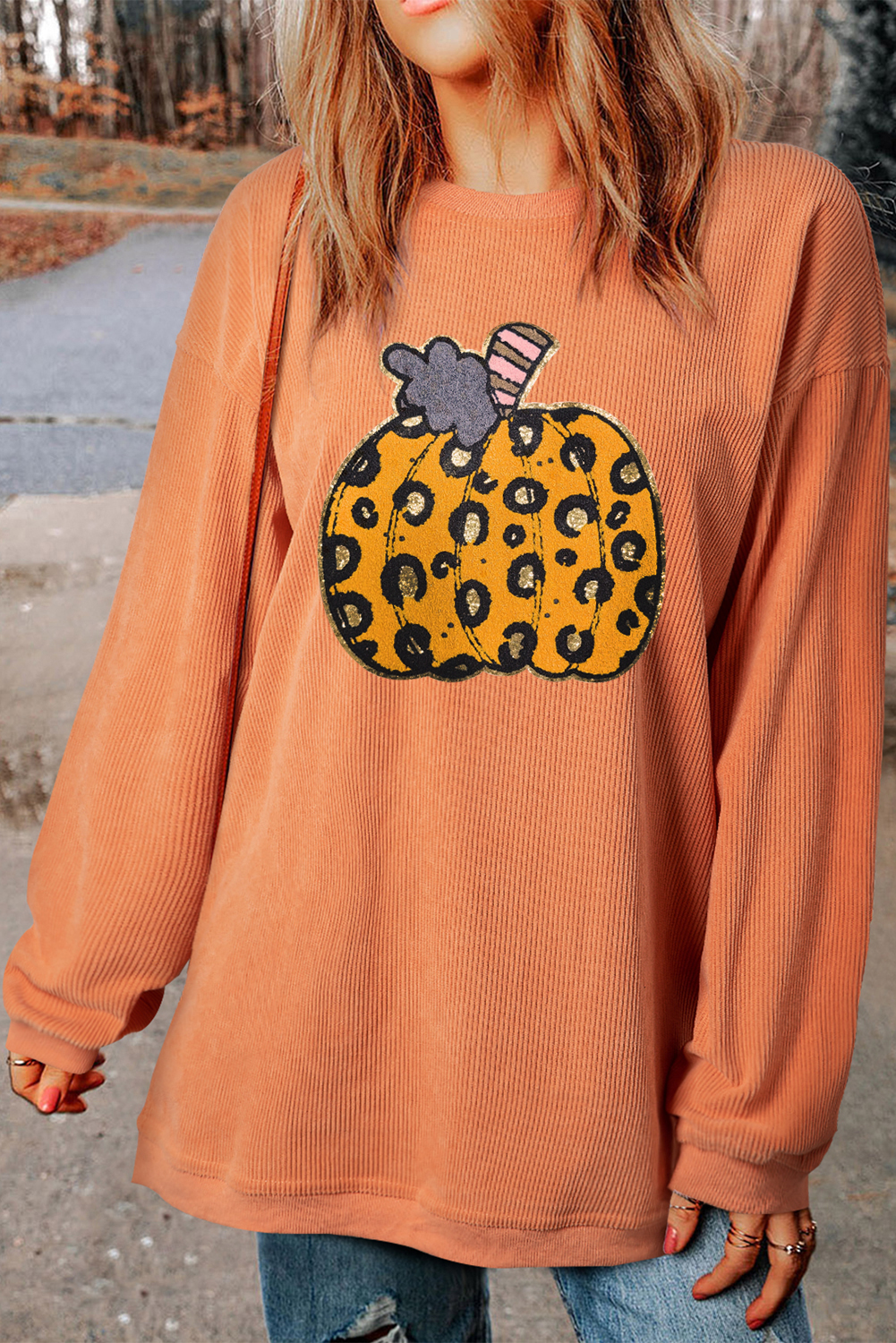 Add a touch of spooky sophistication to your Halloween outfit with this Women's Orange Leopard Pumpkin Patchwork Ribbed Sweatshirt. The bold and playful design features a vibrant orange color with a leopard print pumpkin patchwork pattern, creating a one-of-a-kind look. The ribbed details add texture and style, making it a comfortable and cozy choice for the autumn season. Pair it with leggings or jeans for a stylish and festive look that's perfect for Halloween parties and autumn celebrations. This graphic sweatshirt is made from 100% polyester and ensures a comfortable wear for chilly fall days. Get ready to shine this Halloween season with this fierce and festive sweatshirt! - Detail View 4 Add a touch of spooky sophistication to your Halloween outfit with this Women's Orange Leopard Pumpkin Patchwork Ribbed Sweatshirt. The bold and playful design features a vibrant orange color with a leopard print pumpkin patchwork pattern, creating a one-of-a-kind look. The ribbed details add texture and style, making it a comfortable and cozy choice for the autumn season. Pair it with leggings or jeans for a stylish and festive look that's perfect for Halloween parties and autumn celebrations. This graphic sweatshirt is made from 100% polyester and ensures a comfortable wear for chilly fall days. Get ready to shine this Halloween season with this fierce and festive sweatshirt! - Detail View 4