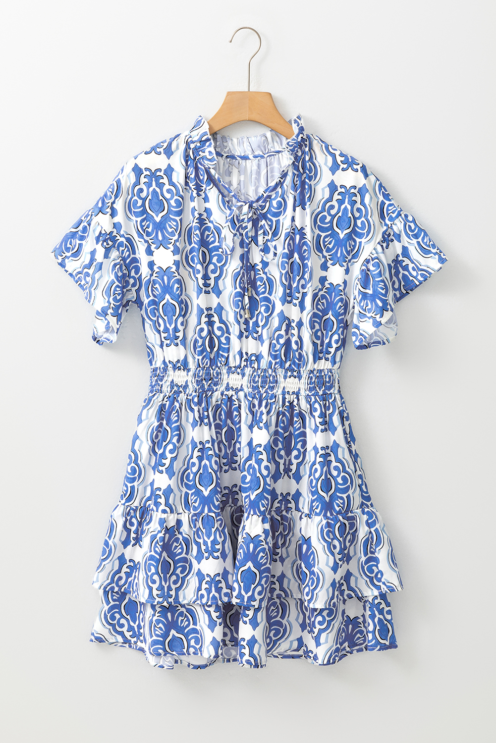 Add a touch of vintage charm to your wardrobe with this elegant Women's Ashleigh Blue Vintage Floral Print Short Sleeve Dress. Made from soft and lightweight polyester, this fashion dress is perfect for the warmer months. The stand-up collar with ruffle details adds a romantic and whimsical touch, while the smocked waist and ruffled hem create a flattering and graceful silhouette. Flattering and comfortable, this dress is perfect for different social occasions, making it suitable for daily wear. The vintage floral print throughout adds a unique and eye-catching touch, allowing you to stand out in public with confidence. Pair it with sandals or sneakers for a casual look or dress it up with heels for a more elegant ensemble. - Detail View 4 Add a touch of vintage charm to your wardrobe with this elegant Women's Ashleigh Blue Vintage Floral Print Short Sleeve Dress. Made from soft and lightweight polyester, this fashion dress is perfect for the warmer months. The stand-up collar with ruffle details adds a romantic and whimsical touch, while the smocked waist and ruffled hem create a flattering and graceful silhouette. Flattering and comfortable, this dress is perfect for different social occasions, making it suitable for daily wear. The vintage floral print throughout adds a unique and eye-catching touch, allowing you to stand out in public with confidence. Pair it with sandals or sneakers for a casual look or dress it up with heels for a more elegant ensemble. - Detail View 4