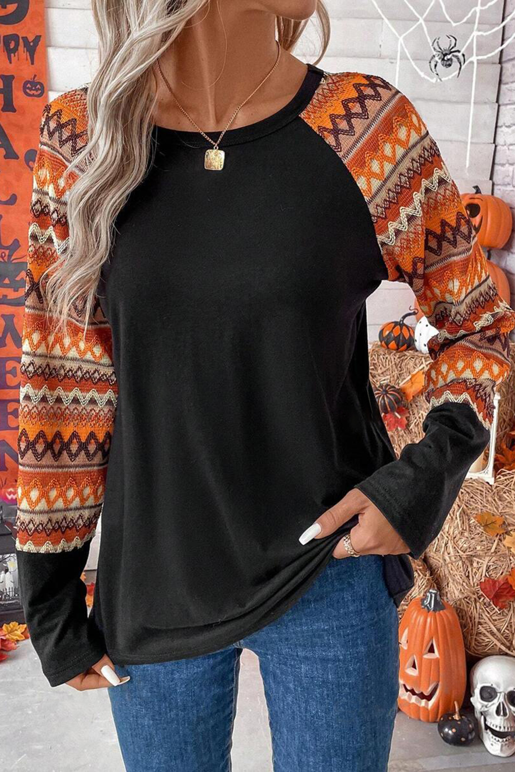 Make a bold and artistic statement with this Women's Orange Geo Print Raglan Patchwork Long Sleeve Tee. The striking geometric pattern adds a touch of creativity and edge to your look, while the casual raglan sleeves ensure unrestricted movement and comfort. Featuring a round neck and long sleeves, this tee offers a classic and versatile style. The creative patchwork detail enhances the distinctive and edgy look of the top, making it a standout piece in your wardrobe. Made from a comfortable blend of 65% polyester, 30% viscose, and 5% elastane, this tee combines casual comfort with fashionable appeal. The orange color and striped pattern add a dynamic and eye-catching element to the design, perfect for the fall and autumn season. Pair it with your favorite jeans or leggings for a stylish and effortless look. - Detail View 4 Make a bold and artistic statement with this Women's Orange Geo Print Raglan Patchwork Long Sleeve Tee. The striking geometric pattern adds a touch of creativity and edge to your look, while the casual raglan sleeves ensure unrestricted movement and comfort. Featuring a round neck and long sleeves, this tee offers a classic and versatile style. The creative patchwork detail enhances the distinctive and edgy look of the top, making it a standout piece in your wardrobe. Made from a comfortable blend of 65% polyester, 30% viscose, and 5% elastane, this tee combines casual comfort with fashionable appeal. The orange color and striped pattern add a dynamic and eye-catching element to the design, perfect for the fall and autumn season. Pair it with your favorite jeans or leggings for a stylish and effortless look. - Detail View 4