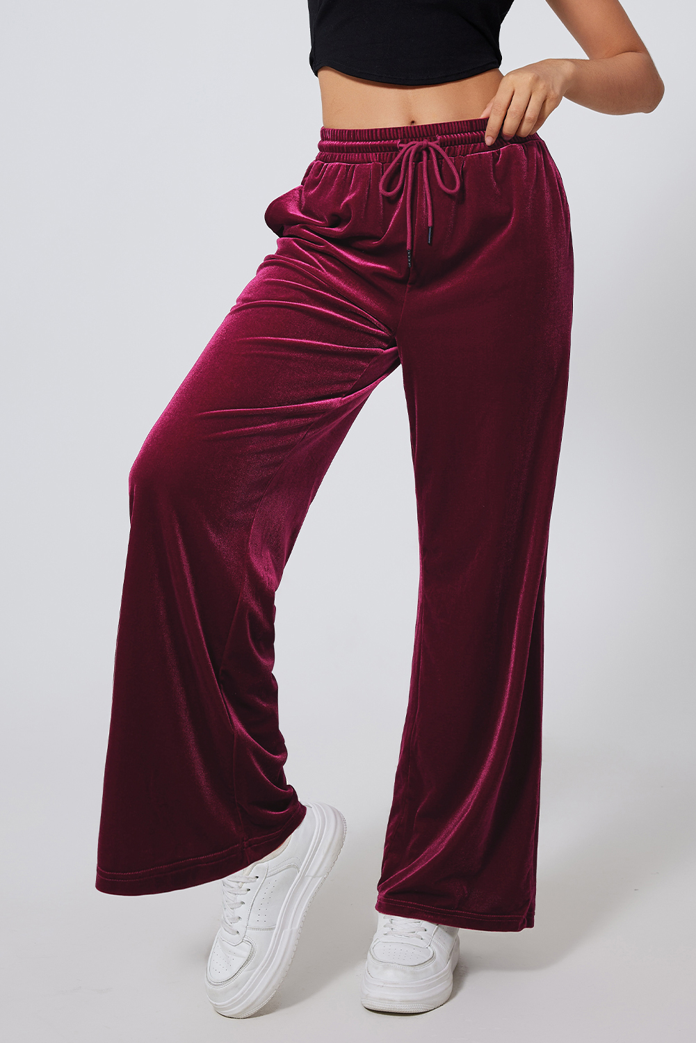 Elevate your style with these Women's Burgundy Solid Drawstring Waist Wide Leg Pants. The versatile drawstring waist allows for an adjustable fit, while the stylish high waist design offers a flattering look. The wide leg silhouette provides a modern and chic appearance, perfect for trendy outfits. Made from a premium blend of 95% polyester and 5% elastane, these pants ensure both comfort and durability. The solid burgundy color adds a touch of sophistication and is available in various solid colors to suit different preferences. Ideal for winter and outdoor activities, these pants are a must-have addition to your wardrobe. Pair them with a trendy top and sneakers for a casual and fashion-forward ensemble. - Detail View 4 Elevate your style with these Women's Burgundy Solid Drawstring Waist Wide Leg Pants. The versatile drawstring waist allows for an adjustable fit, while the stylish high waist design offers a flattering look. The wide leg silhouette provides a modern and chic appearance, perfect for trendy outfits. Made from a premium blend of 95% polyester and 5% elastane, these pants ensure both comfort and durability. The solid burgundy color adds a touch of sophistication and is available in various solid colors to suit different preferences. Ideal for winter and outdoor activities, these pants are a must-have addition to your wardrobe. Pair them with a trendy top and sneakers for a casual and fashion-forward ensemble. - Detail View 4