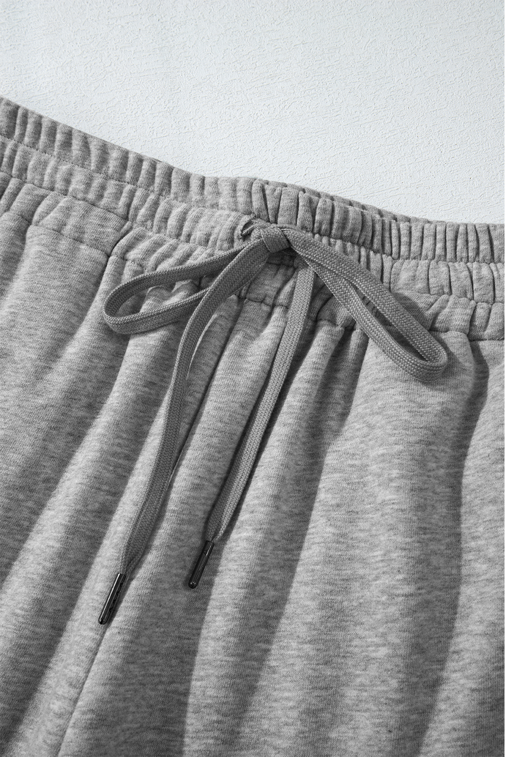 Stay warm and stylish all season long with these Women's Light Grey Solid Color Fleece Lined Drawstring Waist Casual Pants. Made from a comfortable blend of 50% polyester and 50% cotton, these pants feature a plush fleece lining for ultimate warmth and coziness. The straight legs create a relaxed and stylish fit, while the adjustable drawstring waist allows for a personalized feel. The solid light grey color is timeless and versatile, making these casual pants suitable for daily wear and perfect for pairing with your favorite tops. The drawstring waist and side pockets add practicality and convenience, catering to various body types and sizes. Treat yourself to a comfortable and stylish wardrobe essential. - Detail View 9 Stay warm and stylish all season long with these Women's Light Grey Solid Color Fleece Lined Drawstring Waist Casual Pants. Made from a comfortable blend of 50% polyester and 50% cotton, these pants feature a plush fleece lining for ultimate warmth and coziness. The straight legs create a relaxed and stylish fit, while the adjustable drawstring waist allows for a personalized feel. The solid light grey color is timeless and versatile, making these casual pants suitable for daily wear and perfect for pairing with your favorite tops. The drawstring waist and side pockets add practicality and convenience, catering to various body types and sizes. Treat yourself to a comfortable and stylish wardrobe essential. - Detail View 9