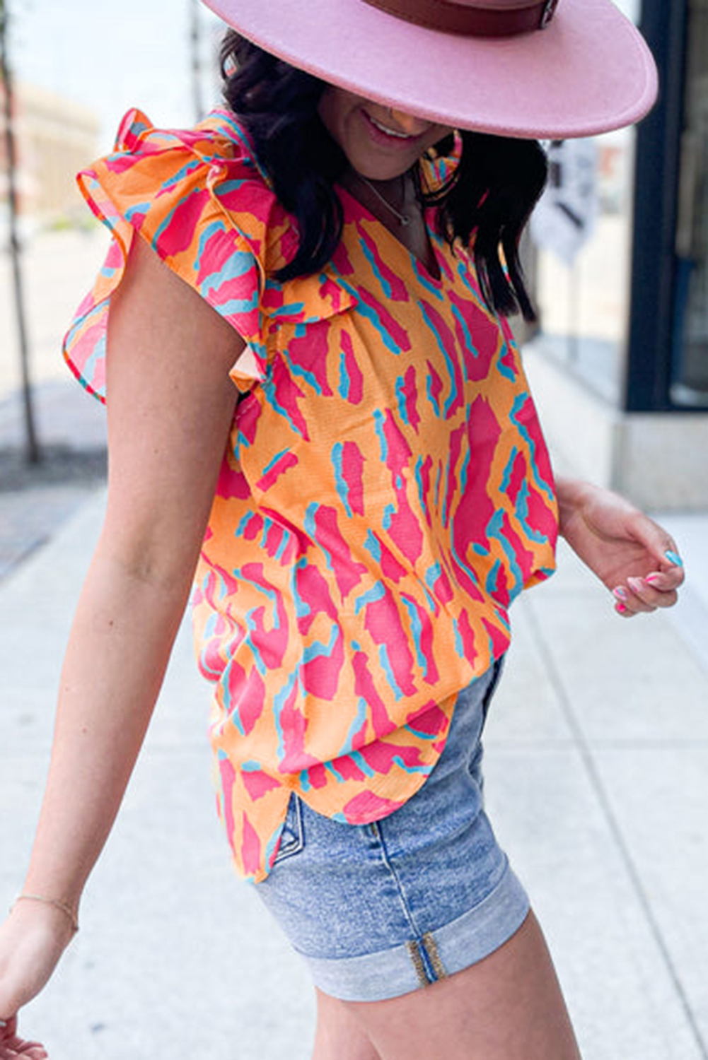 Elevate your casual wardrobe with this Women's Orange Abstract Print V Neck Ruffled Sleeve Blouse. Crafted from lightweight, soft, and fine fabric, this blouse offers exceptional comfort and style. The mango abstract print and double-layer ruffle sleeves make a bold fashion statement, ensuring you get noticed. The loose fit and face-slimming V-neck design add to the effortless charm of this blouse, making it easy to pair with any pants, shorts, or skirts. Whether it's a day out with friends or a casual evening gathering, this blouse is the perfect choice for expressing your unique style. Made with 97% polyester and 3% elastane, it offers durability and flexibility for all-day wear. The geometric pattern and vibrant orange color add a touch of contemporary flair to your ensemble. Embrace your individuality and stand out with this eye-catching and trend-setting blouse. - Detail View 4 Elevate your casual wardrobe with this Women's Orange Abstract Print V Neck Ruffled Sleeve Blouse. Crafted from lightweight, soft, and fine fabric, this blouse offers exceptional comfort and style. The mango abstract print and double-layer ruffle sleeves make a bold fashion statement, ensuring you get noticed. The loose fit and face-slimming V-neck design add to the effortless charm of this blouse, making it easy to pair with any pants, shorts, or skirts. Whether it's a day out with friends or a casual evening gathering, this blouse is the perfect choice for expressing your unique style. Made with 97% polyester and 3% elastane, it offers durability and flexibility for all-day wear. The geometric pattern and vibrant orange color add a touch of contemporary flair to your ensemble. Embrace your individuality and stand out with this eye-catching and trend-setting blouse. - Detail View 4