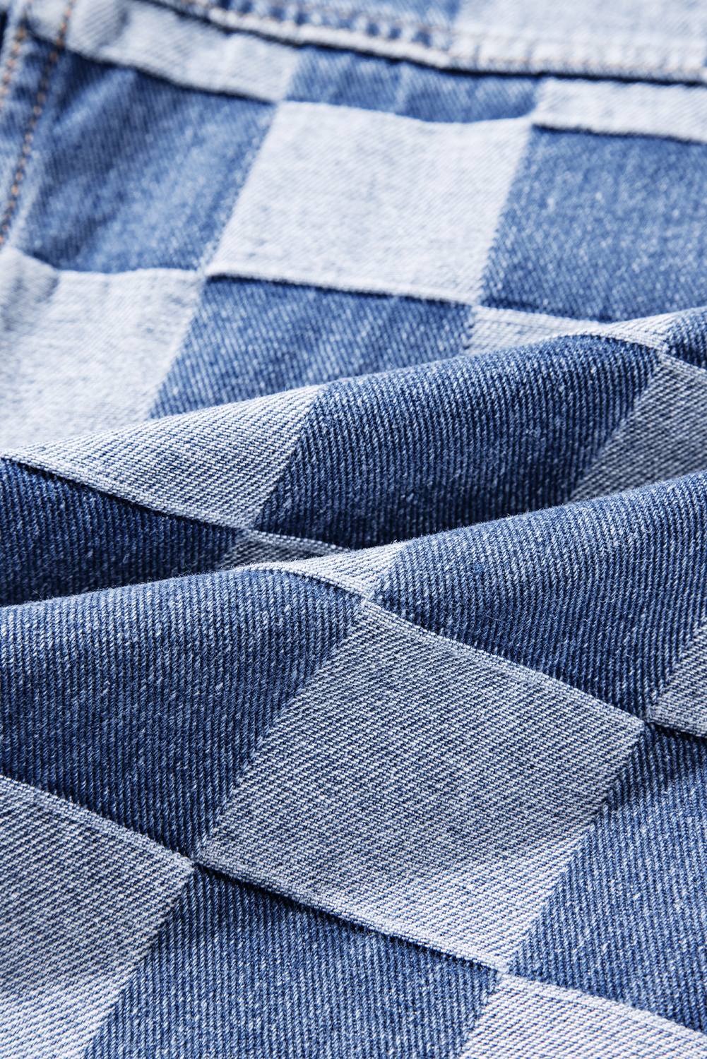 Elevate your casual style with this Women's Light Blue Checkered Patchwork Button-Up Denim Jacket. A unique fusion of classic denim and patchwork style, this jacket features a playful two-tone checkered pattern that adds a fun twist to the traditional denim look. The flap pockets and button-up front not only enhance the jacket's style but also provide practical functionality. Pair it with jeans for a trendy denim-on-denim look, or layer it over a simple tee for a laid-back and effortlessly cool ensemble. Made from a blend of 56% cotton and 44% polyester, this jacket offers both comfort and durability, making it ideal for the fall and autumn seasons. The long sleeves and turn-down collar add to the jacket's classic and timeless appeal. Show off your fashion taste with this stylish and versatile denim jacket. - Detail View 14 Elevate your casual style with this Women's Light Blue Checkered Patchwork Button-Up Denim Jacket. A unique fusion of classic denim and patchwork style, this jacket features a playful two-tone checkered pattern that adds a fun twist to the traditional denim look. The flap pockets and button-up front not only enhance the jacket's style but also provide practical functionality. Pair it with jeans for a trendy denim-on-denim look, or layer it over a simple tee for a laid-back and effortlessly cool ensemble. Made from a blend of 56% cotton and 44% polyester, this jacket offers both comfort and durability, making it ideal for the fall and autumn seasons. The long sleeves and turn-down collar add to the jacket's classic and timeless appeal. Show off your fashion taste with this stylish and versatile denim jacket. - Detail View 14