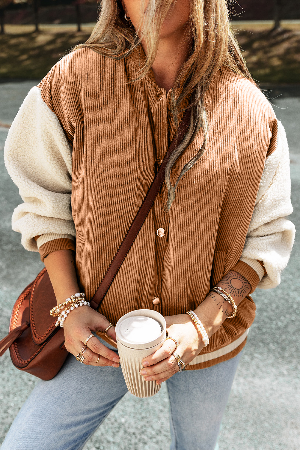 Stay warm and stylish this winter with this Women's Buckskin Corduroy Colorblock Bomber Jacket. The massy construction ensures that you stay cozy and comfortable, while the corduroy fabric adds a rugged charm to the overall design. The flat collar and varsity striped trim add a touch of sophistication, while the snap button front closures make it easy to get in and out. The faux shearling dropped long sleeves with elasticized trim add a luxurious feel to the jacket. This casual winter jacket is perfect for pairing with jeans or casual pants for a complete outfit. Join the latest winter fashion trend with this stylish and functional jacket. - Detail View 4 Stay warm and stylish this winter with this Women's Buckskin Corduroy Colorblock Bomber Jacket. The massy construction ensures that you stay cozy and comfortable, while the corduroy fabric adds a rugged charm to the overall design. The flat collar and varsity striped trim add a touch of sophistication, while the snap button front closures make it easy to get in and out. The faux shearling dropped long sleeves with elasticized trim add a luxurious feel to the jacket. This casual winter jacket is perfect for pairing with jeans or casual pants for a complete outfit. Join the latest winter fashion trend with this stylish and functional jacket. - Detail View 4