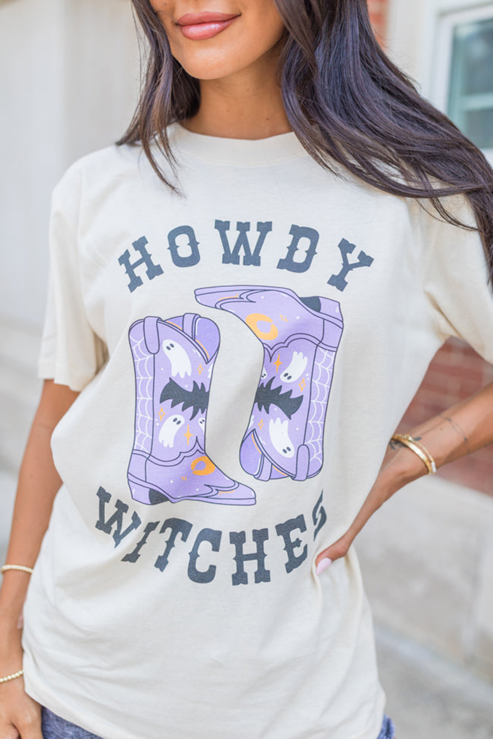 Make a statement with this bold and unique HOWDY WITCHES graphic t-shirt. The classic crew neck design and short sleeves ensure comfort and casual wear, perfect for warm weather. The stunning holidays graphic is sure to stand out and add a touch of whimsy to your outfit. This t-shirt is a must-have for Halloween festivities and summer wear. Pair it with your favorite jeans or shorts for a stylish and effortless look. Graphic tees offer a variety of options to express your personality, making this a great addition to your wardrobe. - Detail View 4 Make a statement with this bold and unique HOWDY WITCHES graphic t-shirt. The classic crew neck design and short sleeves ensure comfort and casual wear, perfect for warm weather. The stunning holidays graphic is sure to stand out and add a touch of whimsy to your outfit. This t-shirt is a must-have for Halloween festivities and summer wear. Pair it with your favorite jeans or shorts for a stylish and effortless look. Graphic tees offer a variety of options to express your personality, making this a great addition to your wardrobe. - Detail View 4
