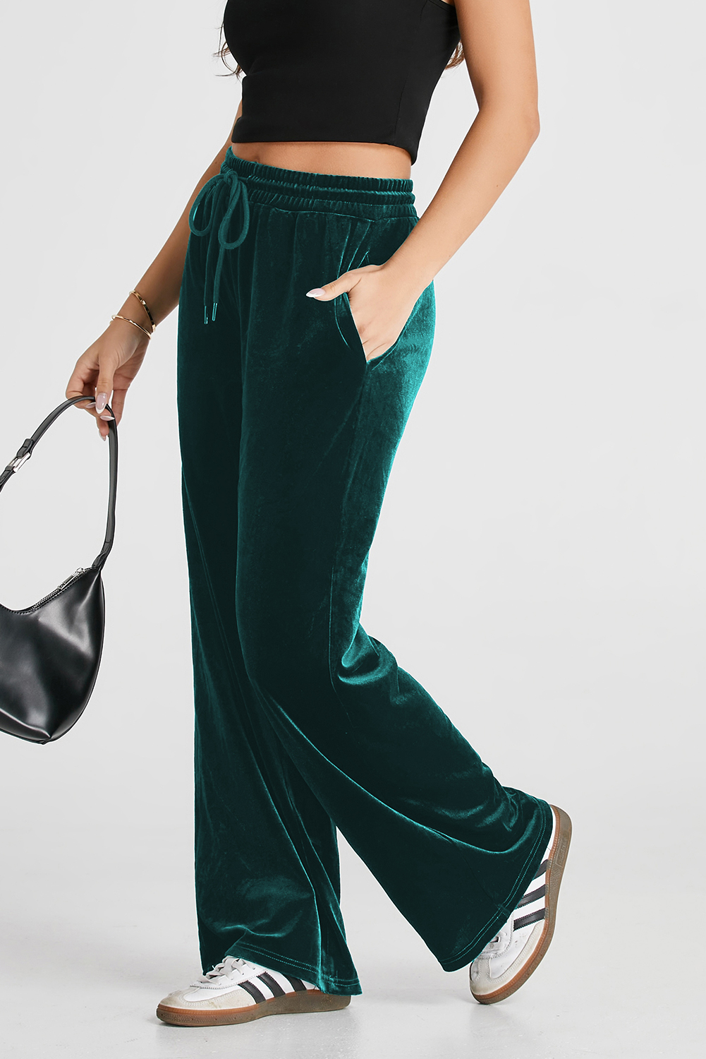 Achieve the perfect blend of style and comfort with these Women's Evergreen Solid Drawstring Waist Wide Leg Pants. The versatile drawstring waist allows for an adjustable fit, while the stylish high waist design offers a flattering look. The wide leg silhouette adds a touch of modernity and chicness to your outfit. Made from premium 95% polyester and 5% elastane, these pants provide both comfort and durability. Available in the elegant Evergreen color and various other solid colors, these pants cater to different style preferences. Perfect for daily wear and outdoor activities, these pants are a must-have addition to your wardrobe. The comfortable and trendy design makes them ideal for creating fashionable and stylish outfits, while the premium fabric ensures long-lasting wear. - Detail View 4 Achieve the perfect blend of style and comfort with these Women's Evergreen Solid Drawstring Waist Wide Leg Pants. The versatile drawstring waist allows for an adjustable fit, while the stylish high waist design offers a flattering look. The wide leg silhouette adds a touch of modernity and chicness to your outfit. Made from premium 95% polyester and 5% elastane, these pants provide both comfort and durability. Available in the elegant Evergreen color and various other solid colors, these pants cater to different style preferences. Perfect for daily wear and outdoor activities, these pants are a must-have addition to your wardrobe. The comfortable and trendy design makes them ideal for creating fashionable and stylish outfits, while the premium fabric ensures long-lasting wear. - Detail View 4