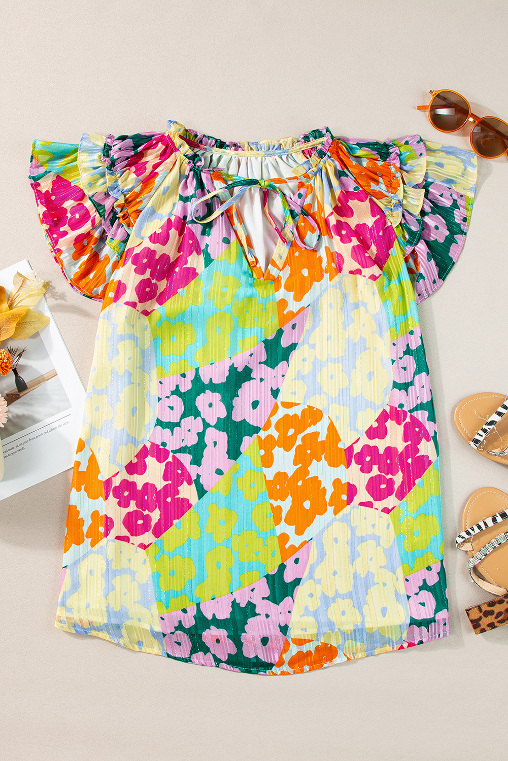 Make a bold fashion statement with this Multicolour Leopard Flutter Sleeve V-Neck Crinkled Blouse. The mix leopard patchwork print is eye-catching and stylish, while the soft lightweight fabric with crinkled textures provides comfort and a unique look. This blouse features a frilly collar, tie split neck, and charming ruffle sleeves, adding a touch of femininity to your ensemble. Create different looks by pairing it with jeans, skirts, or shorts, making it a versatile addition to your wardrobe. Made of high-quality 100% polyester material, this blouse is durable and easy to care for. The elegant V-neckline and cap sleeves enhance the overall appeal, making it suitable for daily wear and special occasions. Embrace your individual style with this chic and elegant blouse. - Detail View 4 Make a bold fashion statement with this Multicolour Leopard Flutter Sleeve V-Neck Crinkled Blouse. The mix leopard patchwork print is eye-catching and stylish, while the soft lightweight fabric with crinkled textures provides comfort and a unique look. This blouse features a frilly collar, tie split neck, and charming ruffle sleeves, adding a touch of femininity to your ensemble. Create different looks by pairing it with jeans, skirts, or shorts, making it a versatile addition to your wardrobe. Made of high-quality 100% polyester material, this blouse is durable and easy to care for. The elegant V-neckline and cap sleeves enhance the overall appeal, making it suitable for daily wear and special occasions. Embrace your individual style with this chic and elegant blouse. - Detail View 4