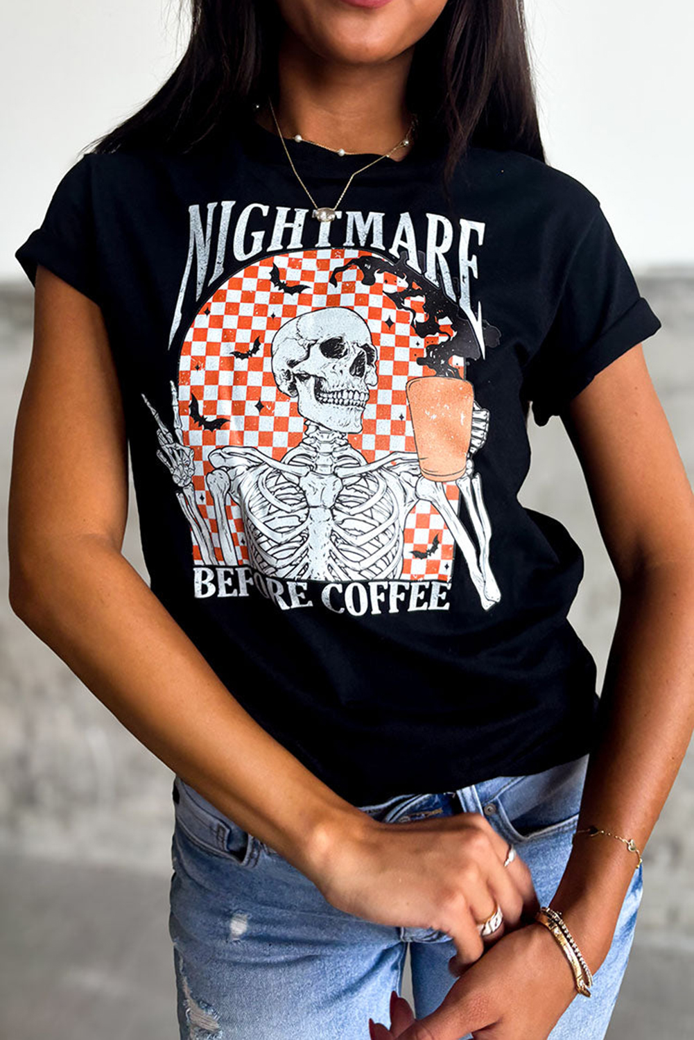 Get ready for a spooky Halloween with this Women's Black Skull Checkerboard Graphic Halloween Tee. Featuring a chill skull design on a checkered background, this graphic tee adds a touch of darkness to your style. The comfortable crew neck and relaxed shift fit make it perfect for casual wear, while the graphic design is sure to spark conversations at Halloween parties. This tee is a must-have for Halloween enthusiasts and casual goths, and the premium material ensures durability and comfort. Pair it with your favorite jeans and boots for a chic and spooky look. - Detail View 4 Get ready for a spooky Halloween with this Women's Black Skull Checkerboard Graphic Halloween Tee. Featuring a chill skull design on a checkered background, this graphic tee adds a touch of darkness to your style. The comfortable crew neck and relaxed shift fit make it perfect for casual wear, while the graphic design is sure to spark conversations at Halloween parties. This tee is a must-have for Halloween enthusiasts and casual goths, and the premium material ensures durability and comfort. Pair it with your favorite jeans and boots for a chic and spooky look. - Detail View 4