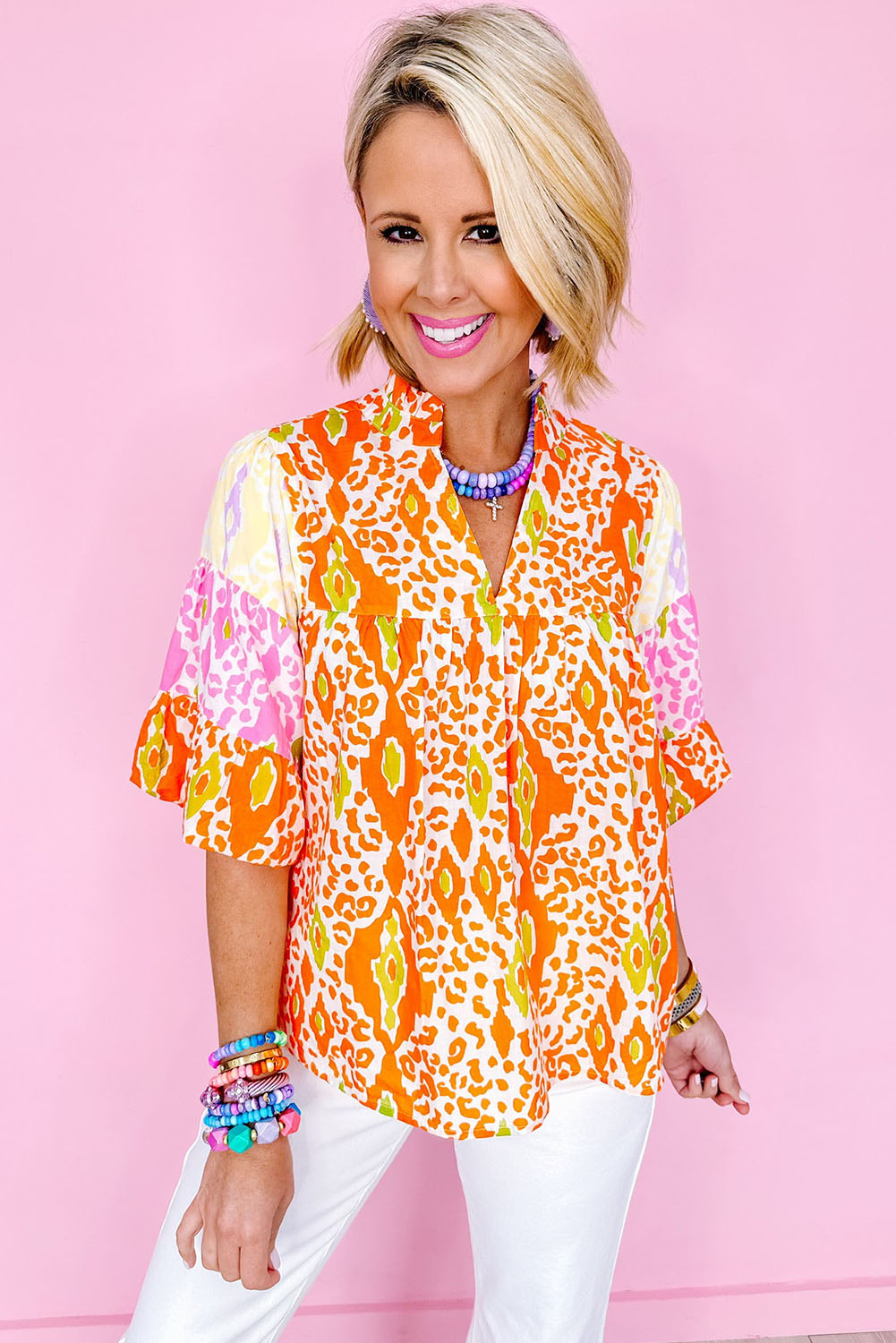 Make a fierce and trendy statement with this Women's Orange Leopard Colorblock Puff Sleeve Split Neck Blouse. The bold leopard print combined with the modern colorblock design adds a fashionable and edgy twist to the blouse, making it a standout piece in your wardrobe. The stylish puff sleeves create an eye-catching silhouette, while the flattering V neckline adds a touch of chic elegance. Made from premium 100% polyester, this blouse offers both comfort and durability. The versatile style of this blouse allows for various wardrobe combinations, making it a must-have for your summer wardrobe update. Whether you're dressing up for a special occasion or keeping it casual for daily wear, this blouse offers endless styling possibilities and is sure to turn heads. - Detail View 4 Make a fierce and trendy statement with this Women's Orange Leopard Colorblock Puff Sleeve Split Neck Blouse. The bold leopard print combined with the modern colorblock design adds a fashionable and edgy twist to the blouse, making it a standout piece in your wardrobe. The stylish puff sleeves create an eye-catching silhouette, while the flattering V neckline adds a touch of chic elegance. Made from premium 100% polyester, this blouse offers both comfort and durability. The versatile style of this blouse allows for various wardrobe combinations, making it a must-have for your summer wardrobe update. Whether you're dressing up for a special occasion or keeping it casual for daily wear, this blouse offers endless styling possibilities and is sure to turn heads. - Detail View 4