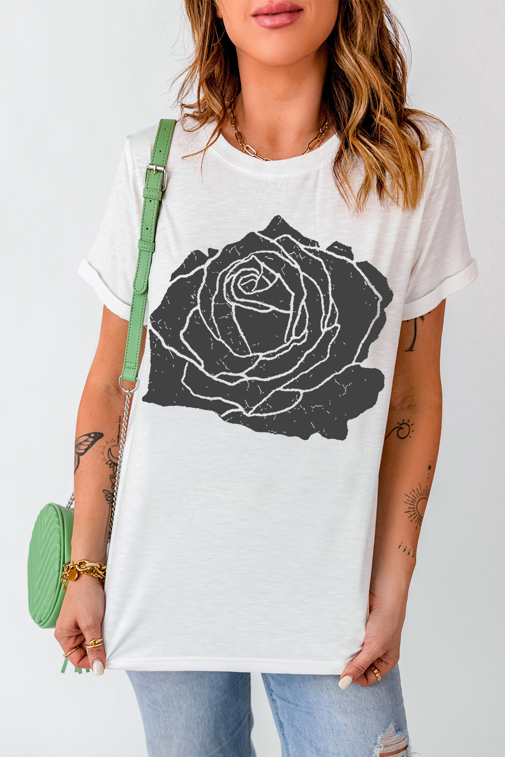 Elevate your style with this Women's White Large Rose Print Round Neck Short Sleeve Graphic T-Shirt. The delicate rose pattern adds a touch of femininity and romance to your outfit, while the breathable and soft fabric ensures all-day comfort. Pair it with jeans or denim shorts for a chic and casual look that's perfect for any occasion. This graphic tee is designed to keep you cool and stylish, featuring a round neck and short sleeves. The large rose print is a beautiful and eye-catching touch that adds visual interest to your outfit. This versatile tee is a must-have addition to your wardrobe, featuring a relaxed fit and easy care design. - Detail View 4 Elevate your style with this Women's White Large Rose Print Round Neck Short Sleeve Graphic T-Shirt. The delicate rose pattern adds a touch of femininity and romance to your outfit, while the breathable and soft fabric ensures all-day comfort. Pair it with jeans or denim shorts for a chic and casual look that's perfect for any occasion. This graphic tee is designed to keep you cool and stylish, featuring a round neck and short sleeves. The large rose print is a beautiful and eye-catching touch that adds visual interest to your outfit. This versatile tee is a must-have addition to your wardrobe, featuring a relaxed fit and easy care design. - Detail View 4