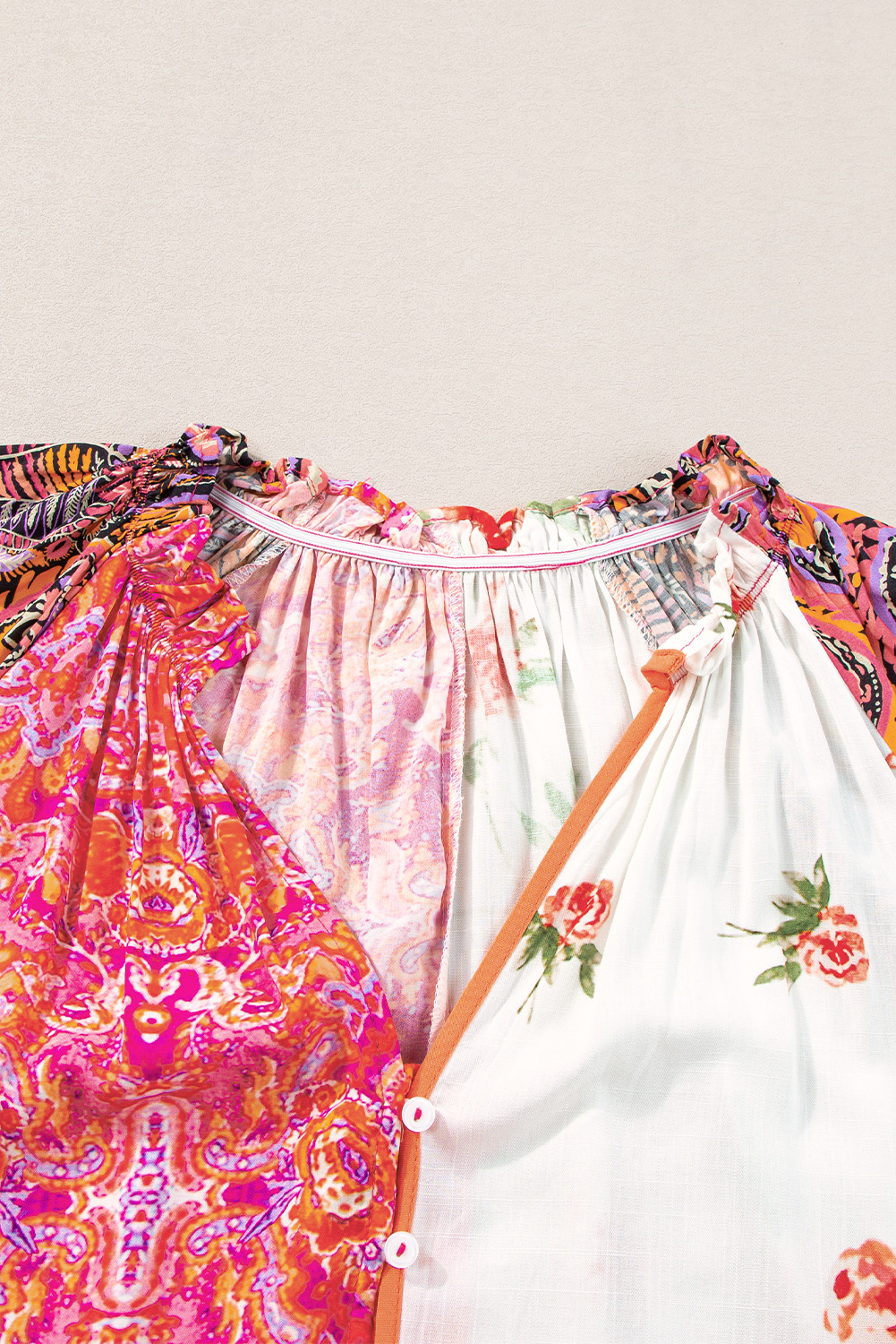 Make a statement with this unique and eye-catching Women's Multicolour Boho Floral Patchwork Buttoned Short Sleeve Blouse. The colorful floral print adds a touch of whimsy and playfulness to the overall design, while the button up front allows you to adjust the neckline and create different styles. The V neckline creates an elongating effect, drawing attention to the collarbone. The flowy silhouette and comfortable fit make it perfect for daily wear, while the 100% viscose material ensures a smooth and soft feel against your skin. This casual blouse is a must-have for your summer wardrobe, offering a unique and elegant look that's sure to turn heads. - Detail View 4 Make a statement with this unique and eye-catching Women's Multicolour Boho Floral Patchwork Buttoned Short Sleeve Blouse. The colorful floral print adds a touch of whimsy and playfulness to the overall design, while the button up front allows you to adjust the neckline and create different styles. The V neckline creates an elongating effect, drawing attention to the collarbone. The flowy silhouette and comfortable fit make it perfect for daily wear, while the 100% viscose material ensures a smooth and soft feel against your skin. This casual blouse is a must-have for your summer wardrobe, offering a unique and elegant look that's sure to turn heads. - Detail View 4