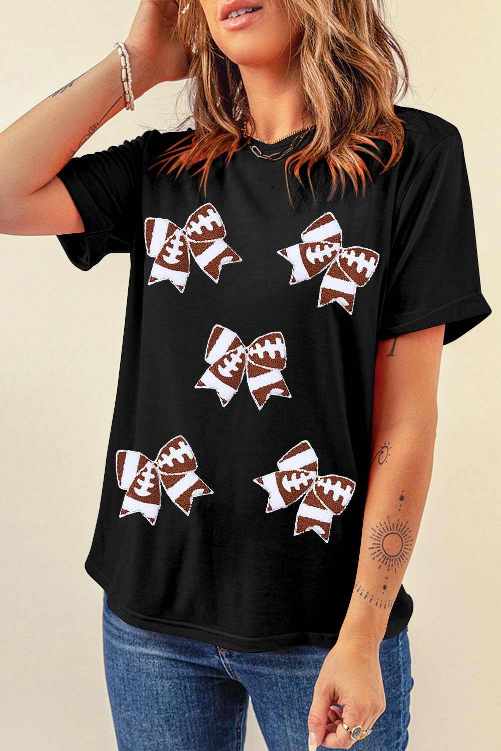 Add a touch of femininity to your game day style with this Women's Black Rugby Football Bowknot Pattern Game Day T-Shirt. Crafted from soft and comfortable material, this tee ensures a relaxed fit and easy movement. The bowknot design adds a charming and playful touch to the sporty rugby football theme, making it perfect for fans of all ages. Pair with your favorite jeans or athletic wear for a stylish and comfortable ensemble. Graphic tees like this one are ideal for exciting game days, and its casual style makes it perfect for daily wear. Show your team pride and add a dash of femininity to your game day look with this unique and charming tee. - Detail View 4 Add a touch of femininity to your game day style with this Women's Black Rugby Football Bowknot Pattern Game Day T-Shirt. Crafted from soft and comfortable material, this tee ensures a relaxed fit and easy movement. The bowknot design adds a charming and playful touch to the sporty rugby football theme, making it perfect for fans of all ages. Pair with your favorite jeans or athletic wear for a stylish and comfortable ensemble. Graphic tees like this one are ideal for exciting game days, and its casual style makes it perfect for daily wear. Show your team pride and add a dash of femininity to your game day look with this unique and charming tee. - Detail View 4