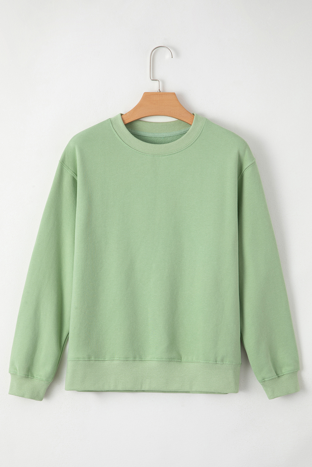 Stay warm and cozy this winter with this Women's Smoke Green Solid Drop Shoulder Fleece Lined Sweatshirt. The simple yet stylish design makes it perfect for versatile wear, while the fleece lining provides extra warmth and comfort in cold weather. The drop shoulder design adds a modern touch, making it a great addition to your winter wardrobe. The long sleeves ensure comfort and warmth, and the solid smoke green color is easy to style with your favorite jeans or leggings. This sweatshirt is a must-have for your cold weather wardrobe, featuring a comfortable and stylish design. - Detail View 9 Stay warm and cozy this winter with this Women's Smoke Green Solid Drop Shoulder Fleece Lined Sweatshirt. The simple yet stylish design makes it perfect for versatile wear, while the fleece lining provides extra warmth and comfort in cold weather. The drop shoulder design adds a modern touch, making it a great addition to your winter wardrobe. The long sleeves ensure comfort and warmth, and the solid smoke green color is easy to style with your favorite jeans or leggings. This sweatshirt is a must-have for your cold weather wardrobe, featuring a comfortable and stylish design. - Detail View 9