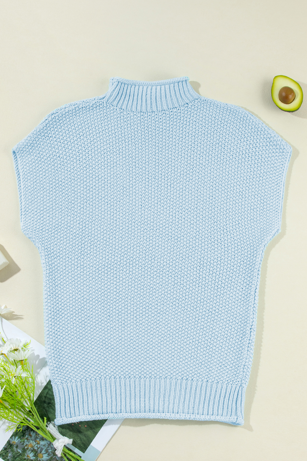 Elevate your casual wardrobe with this Women's Iceland Blue High Neck Bat Wing Sleeveless Knitted Sweater. Featuring a unique textured finish and batwing sleeves, this sweater provides a stylish silhouette for any occasion. The solid color design ensures versatility, allowing you to easily pair it with your favorite bottoms and shoes. The high neck design adds a sophisticated touch, making it perfect for both daily wear and special occasions. The lightweight and breathable material used in this sweater is made from 60% cotton and 40% acrylic, ensuring all-day comfort and ease. Style it with a pair of distressed denim jeans for a trendy look or with a flowy skirt for a feminine touch. This sweater vest is a must-have addition to your wardrobe, offering effortless style and a touch of sophistication. - Detail View 9 Elevate your casual wardrobe with this Women's Iceland Blue High Neck Bat Wing Sleeveless Knitted Sweater. Featuring a unique textured finish and batwing sleeves, this sweater provides a stylish silhouette for any occasion. The solid color design ensures versatility, allowing you to easily pair it with your favorite bottoms and shoes. The high neck design adds a sophisticated touch, making it perfect for both daily wear and special occasions. The lightweight and breathable material used in this sweater is made from 60% cotton and 40% acrylic, ensuring all-day comfort and ease. Style it with a pair of distressed denim jeans for a trendy look or with a flowy skirt for a feminine touch. This sweater vest is a must-have addition to your wardrobe, offering effortless style and a touch of sophistication. - Detail View 9