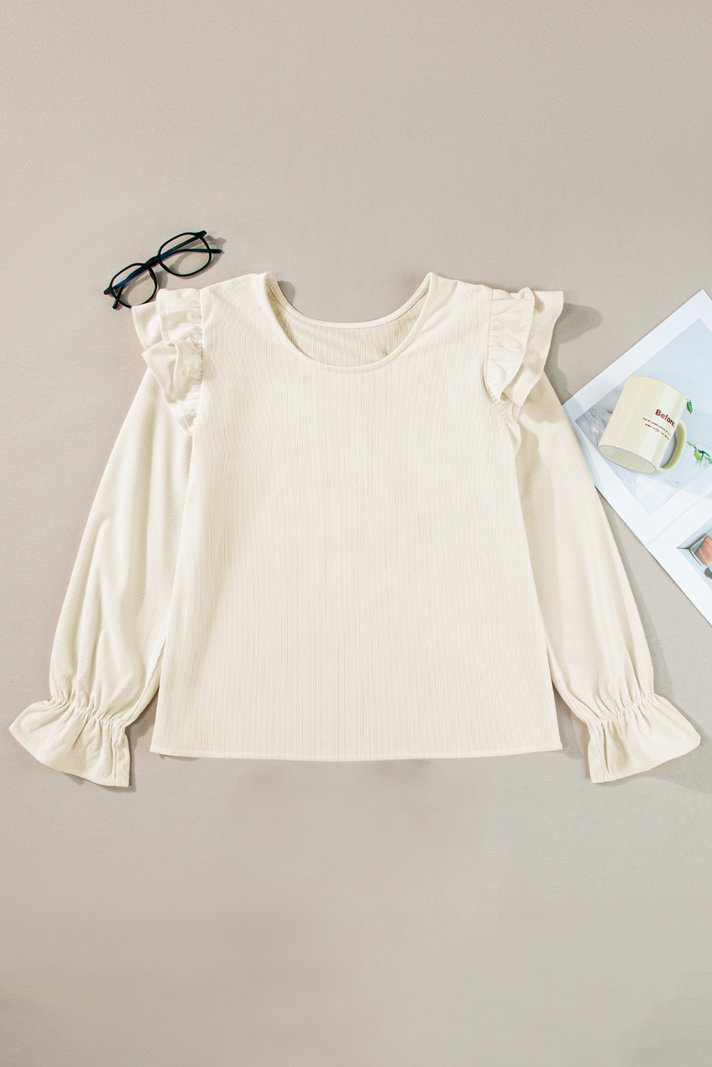 Discover effortless chic with this Women's Elegant Beige Ruffled Flounce Sleeve Corduroy Blouse. Perfect for pairing with jeans or skinny pants, this blouse exudes a fashionable and elegant vibe. The flounce sleeves add a romantic touch, while the round neck design creates a flattering silhouette. The solid beige color ensures a timeless and versatile look, perfect for daily wear. Made from premium 100% polyester corduroy, this blouse is durable and easy to care for. With its classic design and delicate ruffles, this blouse is sure to add a touch of glamour to any outfit. Whether dressing up or keeping it casual, this elegant blouse is a wardrobe staple - Detail View 4 Discover effortless chic with this Women's Elegant Beige Ruffled Flounce Sleeve Corduroy Blouse. Perfect for pairing with jeans or skinny pants, this blouse exudes a fashionable and elegant vibe. The flounce sleeves add a romantic touch, while the round neck design creates a flattering silhouette. The solid beige color ensures a timeless and versatile look, perfect for daily wear. Made from premium 100% polyester corduroy, this blouse is durable and easy to care for. With its classic design and delicate ruffles, this blouse is sure to add a touch of glamour to any outfit. Whether dressing up or keeping it casual, this elegant blouse is a wardrobe staple - Detail View 4