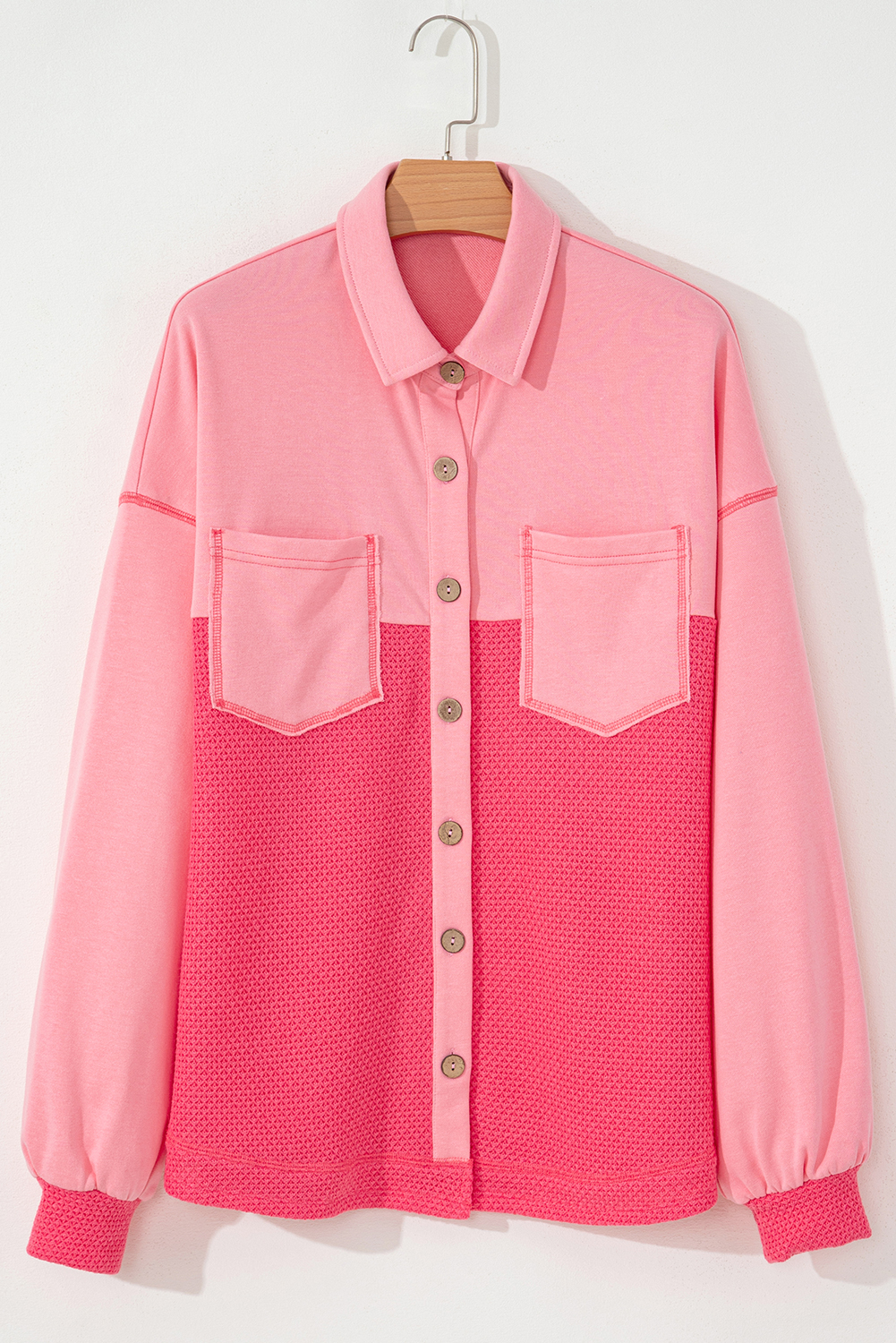 Stay warm and stylish with this Women's Peach Blossom Two Tone Waffle Knit Buttoned Shacket. The two-tone design adds a modern twist to your outfit, while the waffle knit texture provides a cozy and stylish look. The easy-to-use button closure ensures convenience, and the loose fit offers a relaxed and comfortable feel. This shacket is perfect for layering in cold weather, making it an essential addition to your fall and autumn wardrobe. Pair it with jeans and boots for a chic and effortless look. Made from a soft and durable blend of 90% polyester, 7% acrylic, and 3% elastane, this shacket ensures both comfort and long-lasting wear. - Detail View 4 Stay warm and stylish with this Women's Peach Blossom Two Tone Waffle Knit Buttoned Shacket. The two-tone design adds a modern twist to your outfit, while the waffle knit texture provides a cozy and stylish look. The easy-to-use button closure ensures convenience, and the loose fit offers a relaxed and comfortable feel. This shacket is perfect for layering in cold weather, making it an essential addition to your fall and autumn wardrobe. Pair it with jeans and boots for a chic and effortless look. Made from a soft and durable blend of 90% polyester, 7% acrylic, and 3% elastane, this shacket ensures both comfort and long-lasting wear. - Detail View 4