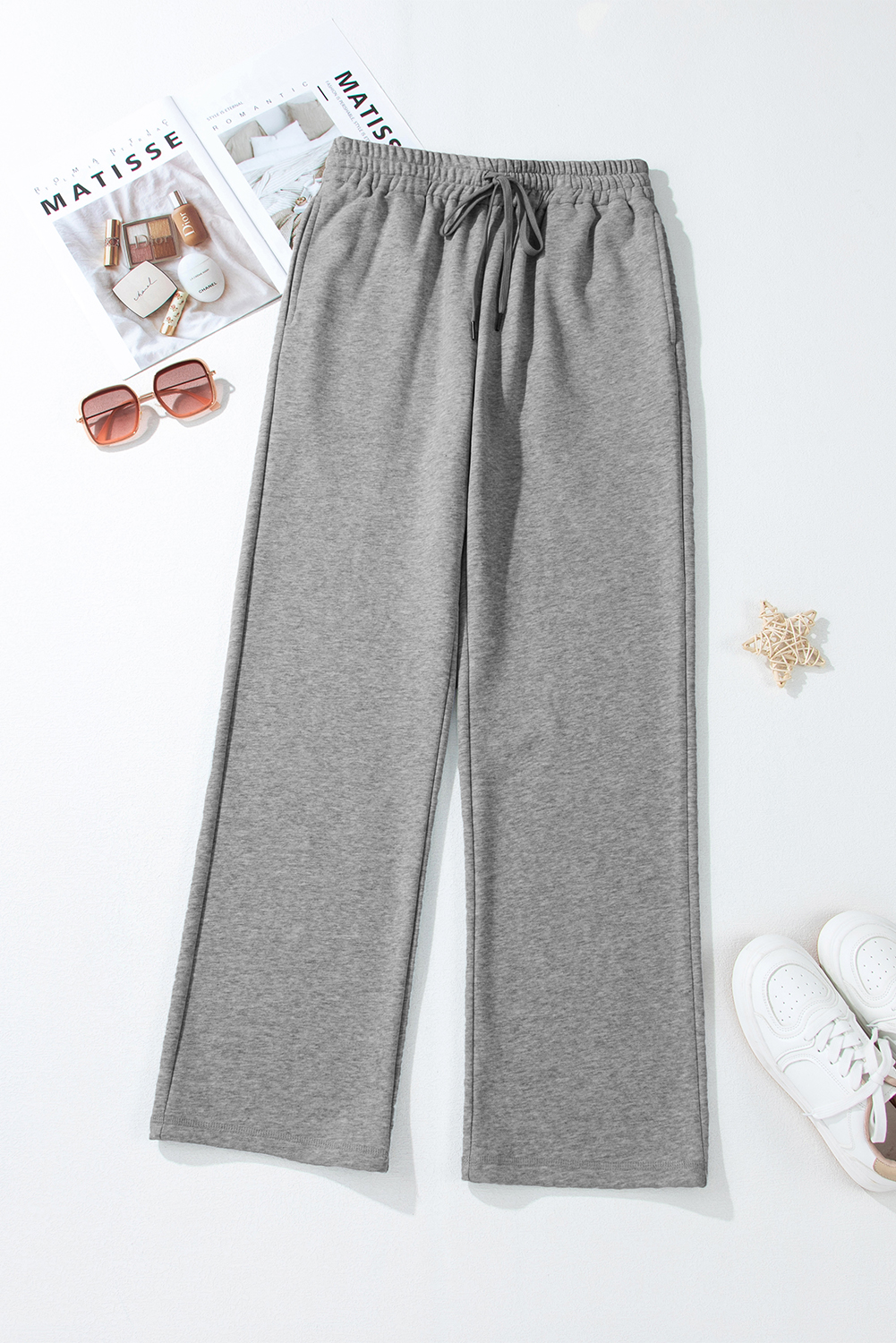 Stay warm and stylish all season long with these Women's Light Grey Solid Color Fleece Lined Drawstring Waist Casual Pants. Made from a comfortable blend of 50% polyester and 50% cotton, these pants feature a plush fleece lining for ultimate warmth and coziness. The straight legs create a relaxed and stylish fit, while the adjustable drawstring waist allows for a personalized feel. The solid light grey color is timeless and versatile, making these casual pants suitable for daily wear and perfect for pairing with your favorite tops. The drawstring waist and side pockets add practicality and convenience, catering to various body types and sizes. Treat yourself to a comfortable and stylish wardrobe essential. - Detail View 4 Stay warm and stylish all season long with these Women's Light Grey Solid Color Fleece Lined Drawstring Waist Casual Pants. Made from a comfortable blend of 50% polyester and 50% cotton, these pants feature a plush fleece lining for ultimate warmth and coziness. The straight legs create a relaxed and stylish fit, while the adjustable drawstring waist allows for a personalized feel. The solid light grey color is timeless and versatile, making these casual pants suitable for daily wear and perfect for pairing with your favorite tops. The drawstring waist and side pockets add practicality and convenience, catering to various body types and sizes. Treat yourself to a comfortable and stylish wardrobe essential. - Detail View 4