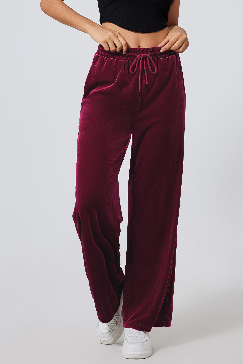 Elevate your style with these Women's Burgundy Solid Drawstring Waist Wide Leg Pants. The versatile drawstring waist allows for an adjustable fit, while the stylish high waist design offers a flattering look. The wide leg silhouette provides a modern and chic appearance, perfect for trendy outfits. Made from a premium blend of 95% polyester and 5% elastane, these pants ensure both comfort and durability. The solid burgundy color adds a touch of sophistication and is available in various solid colors to suit different preferences. Ideal for winter and outdoor activities, these pants are a must-have addition to your wardrobe. Pair them with a trendy top and sneakers for a casual and fashion-forward ensemble. - Detail View 9 Elevate your style with these Women's Burgundy Solid Drawstring Waist Wide Leg Pants. The versatile drawstring waist allows for an adjustable fit, while the stylish high waist design offers a flattering look. The wide leg silhouette provides a modern and chic appearance, perfect for trendy outfits. Made from a premium blend of 95% polyester and 5% elastane, these pants ensure both comfort and durability. The solid burgundy color adds a touch of sophistication and is available in various solid colors to suit different preferences. Ideal for winter and outdoor activities, these pants are a must-have addition to your wardrobe. Pair them with a trendy top and sneakers for a casual and fashion-forward ensemble. - Detail View 9