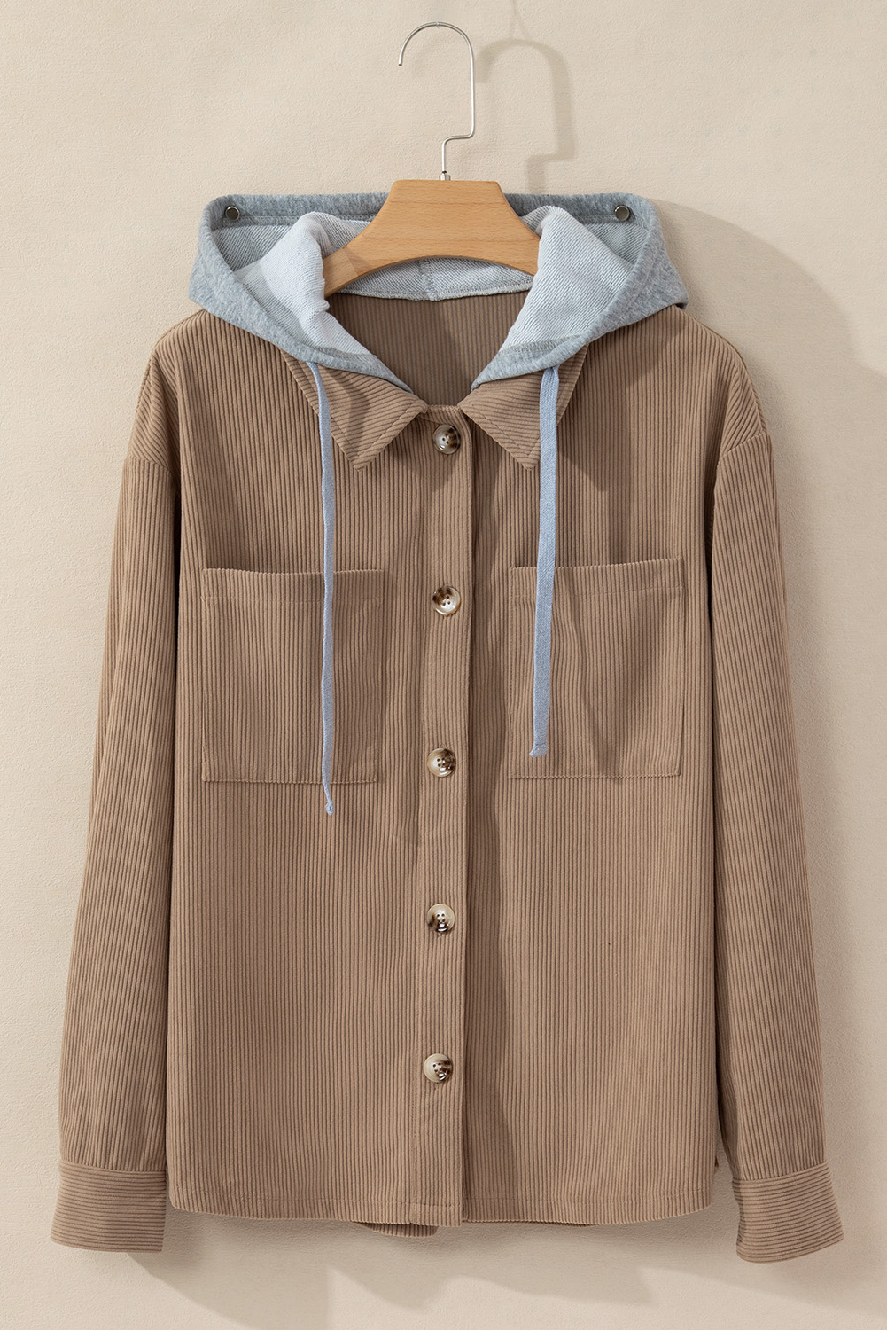 Elevate your winter wardrobe with this Women's Pale Khaki Hooded Drawstring Corduroy Shacket. The shacket features a regular fit with a hood design and drawstring details along the neckline, offering both style and functionality. The button-up front and two chest pockets add a classic and fashionable touch to the shacket. Made from premium 100% polyester corduroy, this shacket is durable and comfortable, making it suitable for all kinds of daily occasions. The solid pale khaki color adds a timeless and versatile appeal to the shacket. Perfect for the winter season, this hooded shacket is designed to keep you warm and stylish. Its chic style and design make it a popular choice among fashion-conscious individuals. Embrace the cozy and trendy vibe with this must-have women's shacket. - Detail View 4 Elevate your winter wardrobe with this Women's Pale Khaki Hooded Drawstring Corduroy Shacket. The shacket features a regular fit with a hood design and drawstring details along the neckline, offering both style and functionality. The button-up front and two chest pockets add a classic and fashionable touch to the shacket. Made from premium 100% polyester corduroy, this shacket is durable and comfortable, making it suitable for all kinds of daily occasions. The solid pale khaki color adds a timeless and versatile appeal to the shacket. Perfect for the winter season, this hooded shacket is designed to keep you warm and stylish. Its chic style and design make it a popular choice among fashion-conscious individuals. Embrace the cozy and trendy vibe with this must-have women's shacket. - Detail View 4
