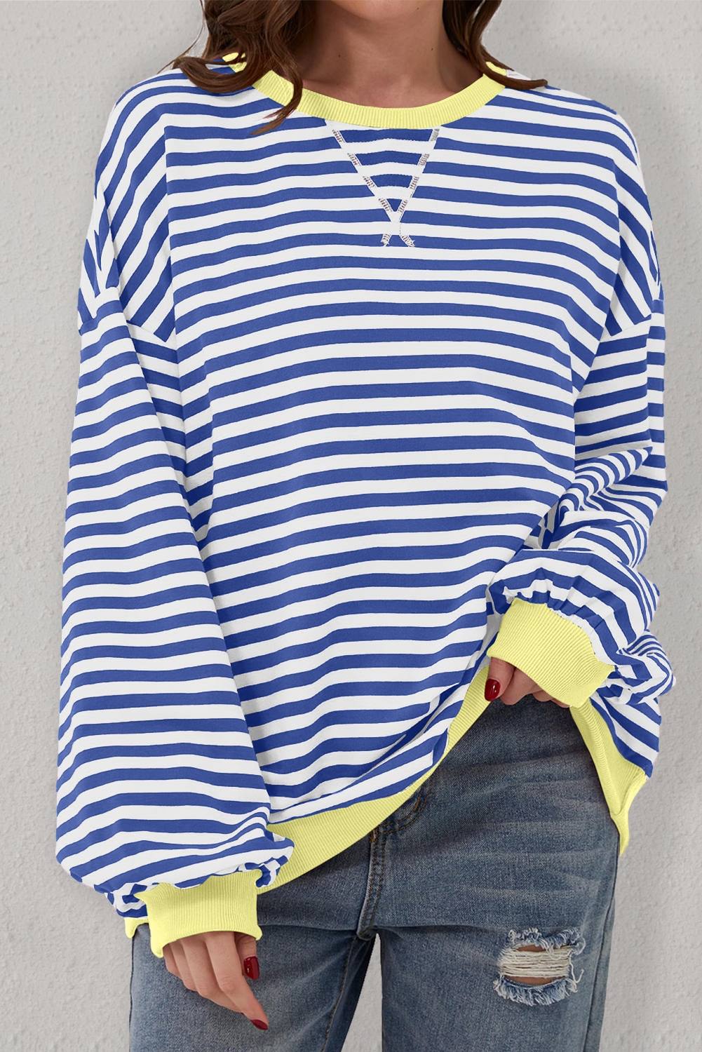 Update your casual wardrobe with this classic Women's Blue Stripe Oversized Contrast Trim Pullover Sweatshirt. The timeless striped pattern adds a touch of sophistication to this casual piece. The oversized style and drop shoulder design give it a casual and slouchy vibe, perfect for comfortable and relaxed wear. The contrast trim detailing adds a pop of color and visual interest to the pullover, making it a stylish addition to your collection. Made from premium 95% cotton and 5% elastane, this sweatshirt offers a very relaxed and comfy fit, suitable for different body shapes. Embrace the latest fashion trend with this chic and versatile sweatshirt, ideal for daily wear in the fall and autumn season. Pair it with your favorite jeans or leggings for a laid-back yet fashionable look. - Detail View 4 Update your casual wardrobe with this classic Women's Blue Stripe Oversized Contrast Trim Pullover Sweatshirt. The timeless striped pattern adds a touch of sophistication to this casual piece. The oversized style and drop shoulder design give it a casual and slouchy vibe, perfect for comfortable and relaxed wear. The contrast trim detailing adds a pop of color and visual interest to the pullover, making it a stylish addition to your collection. Made from premium 95% cotton and 5% elastane, this sweatshirt offers a very relaxed and comfy fit, suitable for different body shapes. Embrace the latest fashion trend with this chic and versatile sweatshirt, ideal for daily wear in the fall and autumn season. Pair it with your favorite jeans or leggings for a laid-back yet fashionable look. - Detail View 4