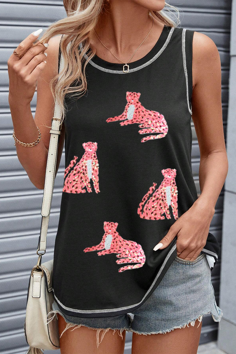 Make a statement with this Women's Black Sequin Cheetah Round Neck Stitching Loose Tank Top. The bold sequin cheetah pattern adds a touch of glamour and makes this tank top a standout piece in your wardrobe. The loose fit and round neck ensure comfort and ease of movement, while the stitching details give it a polished and finished look. Made from a blend of 65% polyester, 30% viscose, and 5% elastane, this tank top offers a comfortable fit and durability. The sleeveless design and casual style make it perfect for the summer season. Pair this graphic tank top with various accessories and outfits to create different stylish looks. Embrace your wild side with this chic and versatile tank top. - Detail View 4 Make a statement with this Women's Black Sequin Cheetah Round Neck Stitching Loose Tank Top. The bold sequin cheetah pattern adds a touch of glamour and makes this tank top a standout piece in your wardrobe. The loose fit and round neck ensure comfort and ease of movement, while the stitching details give it a polished and finished look. Made from a blend of 65% polyester, 30% viscose, and 5% elastane, this tank top offers a comfortable fit and durability. The sleeveless design and casual style make it perfect for the summer season. Pair this graphic tank top with various accessories and outfits to create different stylish looks. Embrace your wild side with this chic and versatile tank top. - Detail View 4