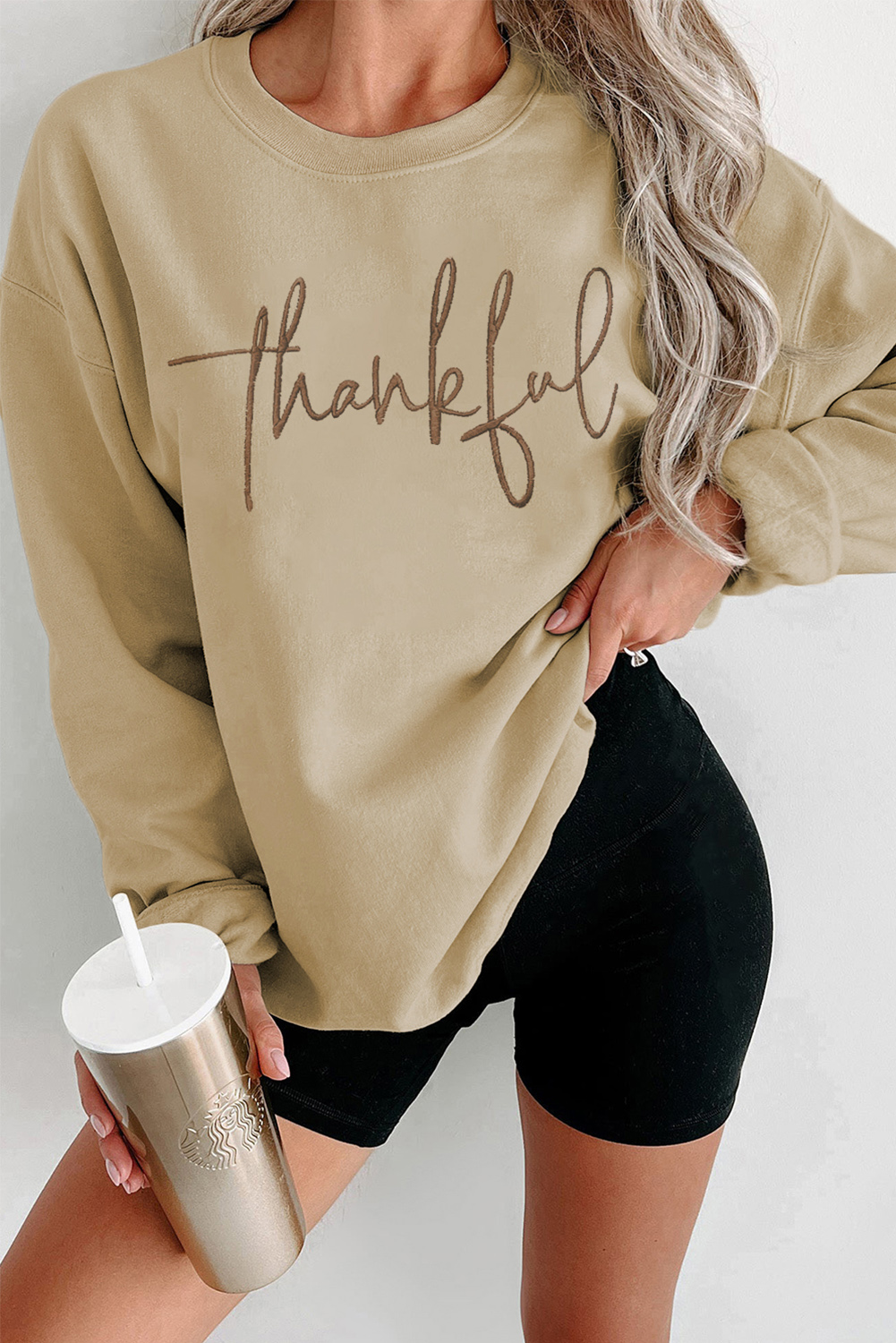 Add a touch of gratitude to your wardrobe with this Women's Parchment Embroidered Drop Shoulder Pullover Sweatshirt. The elegant embroidered design reads 'thankful' in a beautiful font, making it an ideal pick for Thanksgiving Day or any other occasion where you want to express your gratitude. The drop shoulder design and round neckline give the sweatshirt a relaxed and laid-back look, perfect for casual wear. Pair it with your favorite jeans or leggings for a stylish outfit. The parchment color is a unique and eye-catching shade that's perfect for the cooler seasons. This graphic sweatshirt is a must-have for your wardrobe, combining comfort and style. - Detail View 4 Add a touch of gratitude to your wardrobe with this Women's Parchment Embroidered Drop Shoulder Pullover Sweatshirt. The elegant embroidered design reads 'thankful' in a beautiful font, making it an ideal pick for Thanksgiving Day or any other occasion where you want to express your gratitude. The drop shoulder design and round neckline give the sweatshirt a relaxed and laid-back look, perfect for casual wear. Pair it with your favorite jeans or leggings for a stylish outfit. The parchment color is a unique and eye-catching shade that's perfect for the cooler seasons. This graphic sweatshirt is a must-have for your wardrobe, combining comfort and style. - Detail View 4