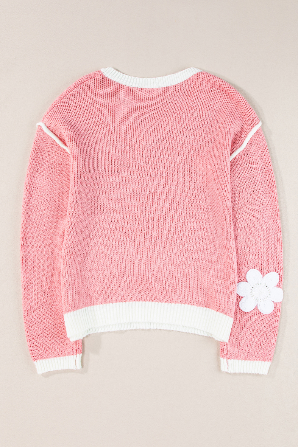 Enchant with the delicate and charming Women's Pink Floral V Neck Dropped Shoulder Sweater. This sweater exudes elegance with its floral design, making it suitable for both casual and dressy occasions. The flattering V neck and relaxed dropped shoulder offer a stylish and comfortable fit. Add a touch of femininity to your wardrobe with this cozy and chic sweater, perfect for adding warmth and flair to your fall ensemble. Made from a premium blend of 60% acrylic and 40% polyamide, this sweater ensures durability and softness against the skin. The long sleeves provide extra warmth, while the pink flower print adds a pop of color and charm. Pair it with your favorite jeans or leggings for a stylish and cozy look. Elevate your style with this elegant and versatile sweater. - Detail View 4 Enchant with the delicate and charming Women's Pink Floral V Neck Dropped Shoulder Sweater. This sweater exudes elegance with its floral design, making it suitable for both casual and dressy occasions. The flattering V neck and relaxed dropped shoulder offer a stylish and comfortable fit. Add a touch of femininity to your wardrobe with this cozy and chic sweater, perfect for adding warmth and flair to your fall ensemble. Made from a premium blend of 60% acrylic and 40% polyamide, this sweater ensures durability and softness against the skin. The long sleeves provide extra warmth, while the pink flower print adds a pop of color and charm. Pair it with your favorite jeans or leggings for a stylish and cozy look. Elevate your style with this elegant and versatile sweater. - Detail View 4