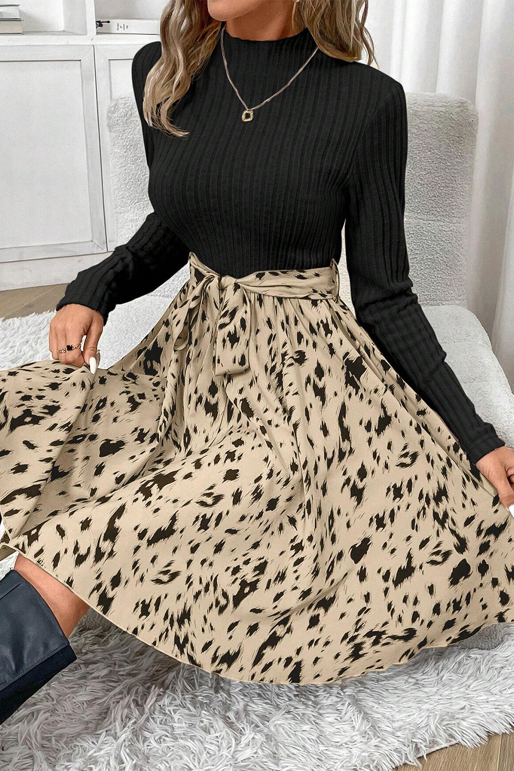 Make a statement with this stylish Women's Black Patchwork Printed Belted A-line Mini Dress. The patchwork design features a flattering A-line silhouette, while the trendy ribbed knit fabric ensures a comfortable and stretchy fit. The eye-catching printed details add a pop of color and personality to the dress. The chic belted waist allows for a customizable fit, making it perfect for both casual outings and special occasions. Whether you're dressing up or dressing down, this dress is sure to impress. With its elegant style and comfortable wear, it's a must-have in your wardrobe. - Detail View 4 Make a statement with this stylish Women's Black Patchwork Printed Belted A-line Mini Dress. The patchwork design features a flattering A-line silhouette, while the trendy ribbed knit fabric ensures a comfortable and stretchy fit. The eye-catching printed details add a pop of color and personality to the dress. The chic belted waist allows for a customizable fit, making it perfect for both casual outings and special occasions. Whether you're dressing up or dressing down, this dress is sure to impress. With its elegant style and comfortable wear, it's a must-have in your wardrobe. - Detail View 4