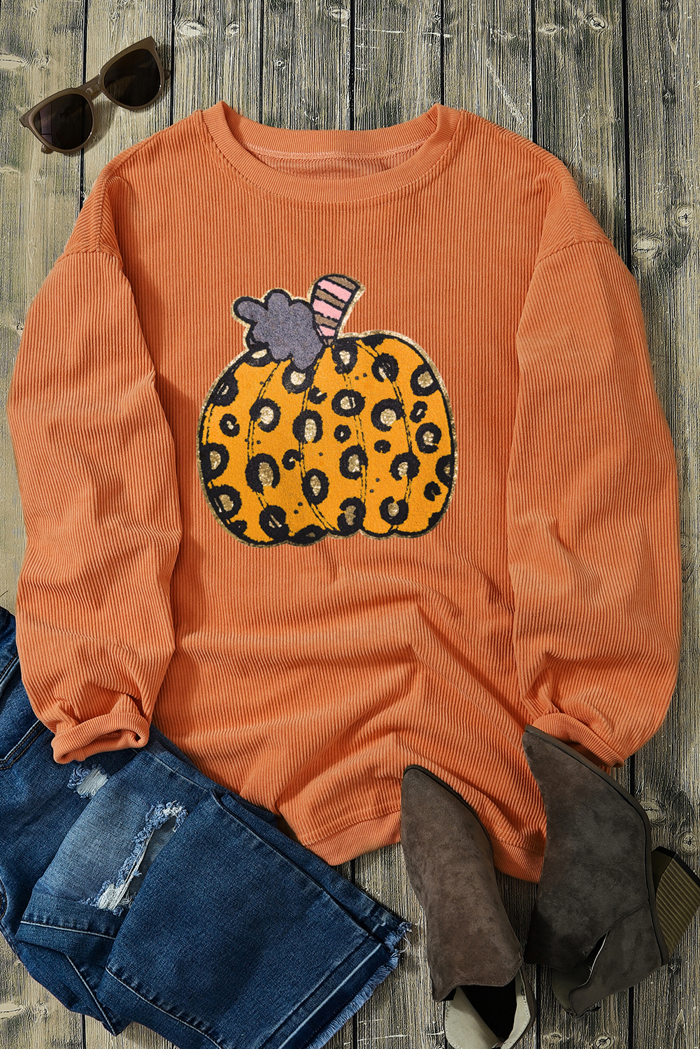 Add a touch of spooky sophistication to your Halloween outfit with this Women's Orange Leopard Pumpkin Patchwork Ribbed Sweatshirt. The bold and playful design features a vibrant orange color with a leopard print pumpkin patchwork pattern, creating a one-of-a-kind look. The ribbed details add texture and style, making it a comfortable and cozy choice for the autumn season. Pair it with leggings or jeans for a stylish and festive look that's perfect for Halloween parties and autumn celebrations. This graphic sweatshirt is made from 100% polyester and ensures a comfortable wear for chilly fall days. Get ready to shine this Halloween season with this fierce and festive sweatshirt! - Detail View 9 Add a touch of spooky sophistication to your Halloween outfit with this Women's Orange Leopard Pumpkin Patchwork Ribbed Sweatshirt. The bold and playful design features a vibrant orange color with a leopard print pumpkin patchwork pattern, creating a one-of-a-kind look. The ribbed details add texture and style, making it a comfortable and cozy choice for the autumn season. Pair it with leggings or jeans for a stylish and festive look that's perfect for Halloween parties and autumn celebrations. This graphic sweatshirt is made from 100% polyester and ensures a comfortable wear for chilly fall days. Get ready to shine this Halloween season with this fierce and festive sweatshirt! - Detail View 9