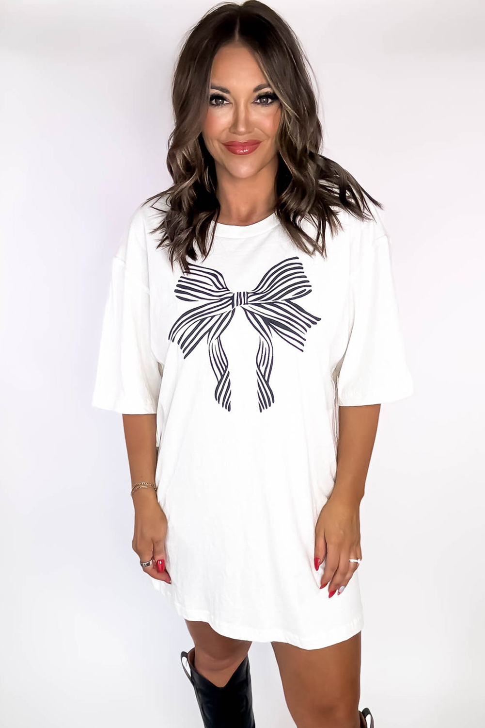 Make a statement with this adorable White Striped Bow Knot Half Sleeve Tunic T-Shirt. The charming knot pattern and striped design combine for a trendy and versatile look that's perfect for everyday wear. The half sleeves and round neckline add a touch of femininity, while the classic tunic length and loose fit ensure a timeless appeal. Crafted from soft and breathable fabric, this graphic tee will keep you comfortable all day long. The bow knot design adds a playful touch, making it a great choice for casual outings or relaxed gatherings with friends. With a basic style and affordable price, this tee is a must-have addition to your wardrobe. - Detail View 4 Make a statement with this adorable White Striped Bow Knot Half Sleeve Tunic T-Shirt. The charming knot pattern and striped design combine for a trendy and versatile look that's perfect for everyday wear. The half sleeves and round neckline add a touch of femininity, while the classic tunic length and loose fit ensure a timeless appeal. Crafted from soft and breathable fabric, this graphic tee will keep you comfortable all day long. The bow knot design adds a playful touch, making it a great choice for casual outings or relaxed gatherings with friends. With a basic style and affordable price, this tee is a must-have addition to your wardrobe. - Detail View 4