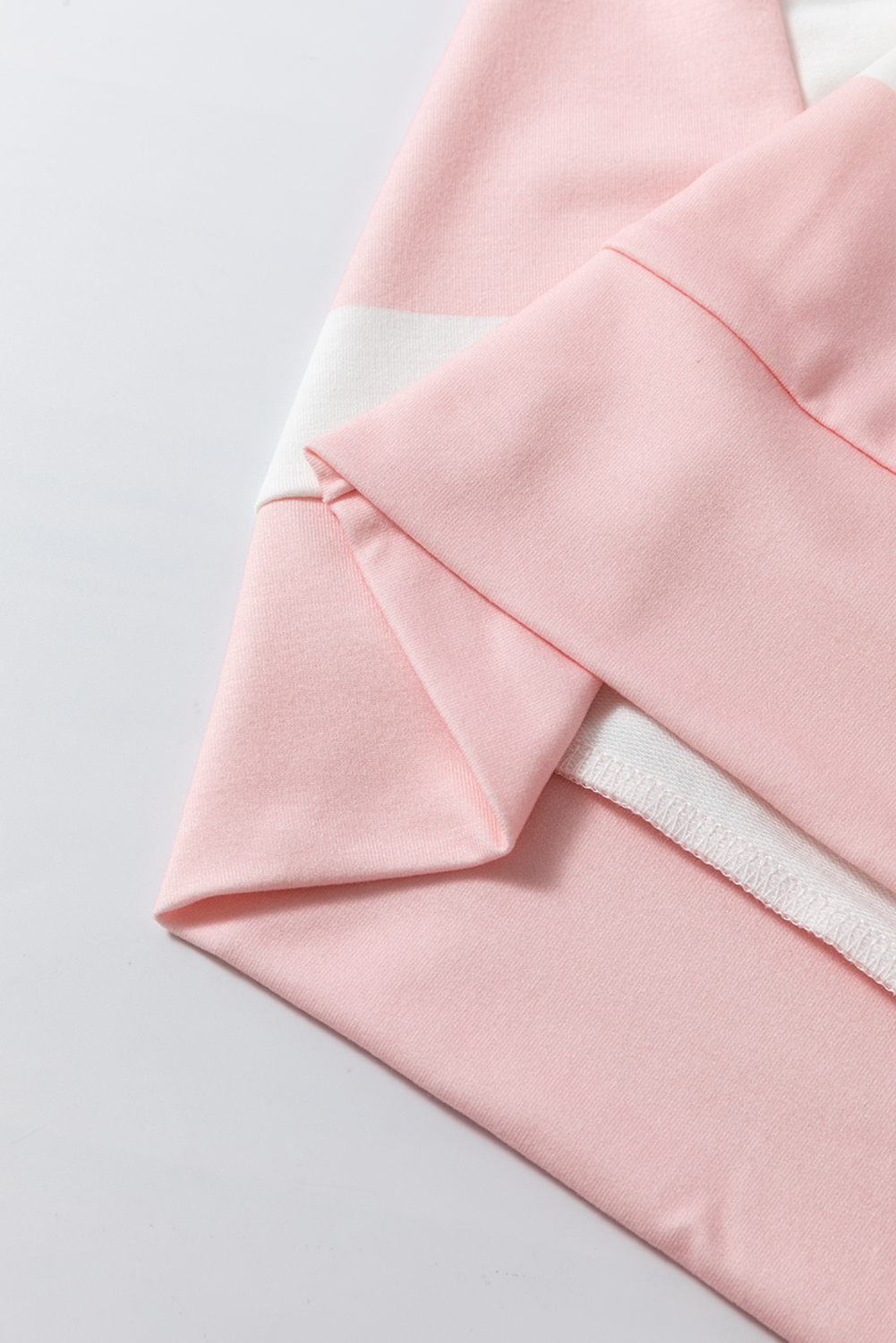 Elevate your casual style with this Light Pink Colorblock Striped Drop Shoulder Long Sleeve Top. The bold colorblock stripes create a fun and modern aesthetic, while the trendy drop shoulder design adds a relaxed and chic touch. The long sleeves provide added warmth and versatility, making this top suitable for various body types and sizes. The round neck and shift silhouette ensure a comfortable and flattering fit. Perfect for daily wear, this top is a must-have for your cozy and stylish wardrobe. Made from a soft and durable blend of 95% polyester and 5% elastane, this top is easy to care for and will retain its shape over time. - Detail View 9 Elevate your casual style with this Light Pink Colorblock Striped Drop Shoulder Long Sleeve Top. The bold colorblock stripes create a fun and modern aesthetic, while the trendy drop shoulder design adds a relaxed and chic touch. The long sleeves provide added warmth and versatility, making this top suitable for various body types and sizes. The round neck and shift silhouette ensure a comfortable and flattering fit. Perfect for daily wear, this top is a must-have for your cozy and stylish wardrobe. Made from a soft and durable blend of 95% polyester and 5% elastane, this top is easy to care for and will retain its shape over time. - Detail View 9