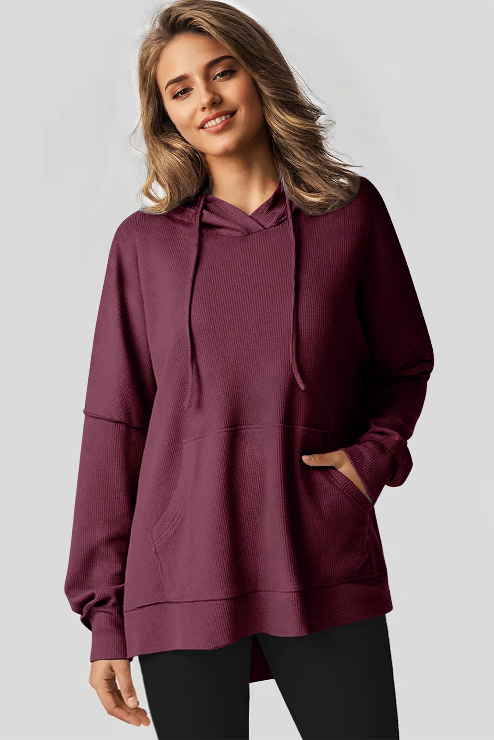 Stay warm and stylish with this Women's Red Dahlia Waffle Knit Fleece Lined Oversized Hoodie. Crafted from soft jacquard knit fabric, this pullover hoodie offers a cozy and comfortable feel. The stylish high-low design and oversized fit enhance a casual and slender silhouette, making it a fashionable choice for the cooler seasons. The convenient kangaroo pocket not only adds a decorative touch but also provides storage for your essentials. The outstanding fleece-lined interior ensures superior warmth and comfort, making it perfect for fall and winter. Made from a premium blend of 75% polyester and 25% cotton, this hoodie offers durability and breathability. The solid red dahlia color adds a pop of brightness to your winter wardrobe. Versatile and stylish, this women's hoodie is a must-have for the upcoming seasons. - Detail View 4 Stay warm and stylish with this Women's Red Dahlia Waffle Knit Fleece Lined Oversized Hoodie. Crafted from soft jacquard knit fabric, this pullover hoodie offers a cozy and comfortable feel. The stylish high-low design and oversized fit enhance a casual and slender silhouette, making it a fashionable choice for the cooler seasons. The convenient kangaroo pocket not only adds a decorative touch but also provides storage for your essentials. The outstanding fleece-lined interior ensures superior warmth and comfort, making it perfect for fall and winter. Made from a premium blend of 75% polyester and 25% cotton, this hoodie offers durability and breathability. The solid red dahlia color adds a pop of brightness to your winter wardrobe. Versatile and stylish, this women's hoodie is a must-have for the upcoming seasons. - Detail View 4
