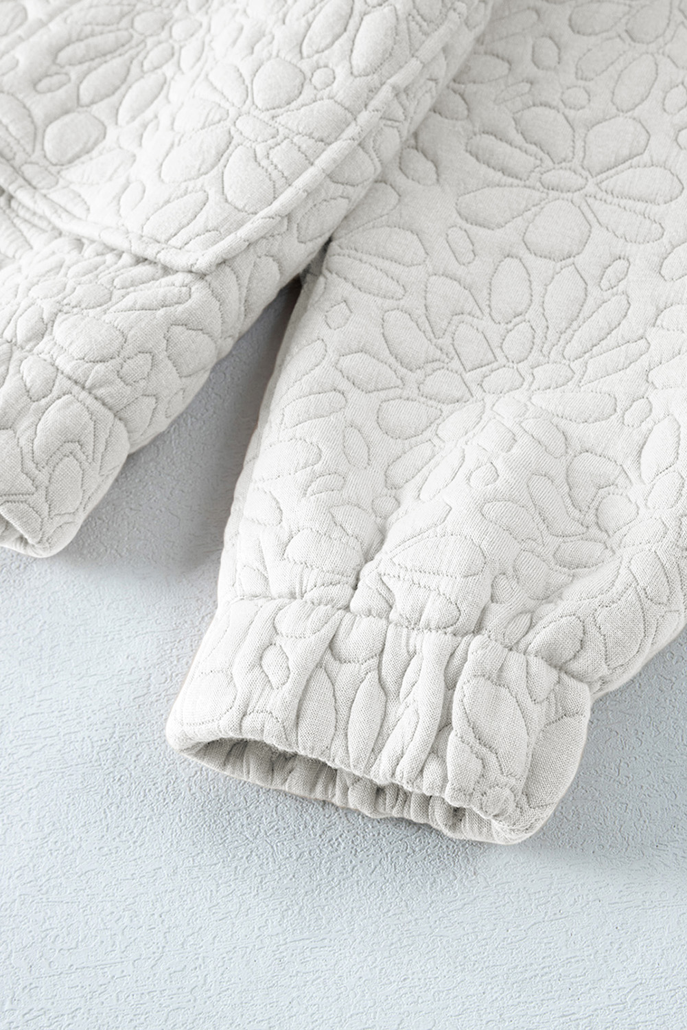 Stay stylish and warm with this Women's White Floral Quilted Long Sleeve Jacket. Featuring a woven quilted fabric in a beautiful floral design, this jacket exudes a modern and chic look. The long sleeves and drop shoulders provide a comfortable fit, while the full zipped closure on the front ensures a secure and adjustable fit. Made from a durable 97% polyester and 3% elastane blend, this jacket is both practical and stylish. The solid white color makes it easy to pair with your favorite outfits, and its concise and versatile design makes it suitable for daily wear during the winter season. This jacket is a must-have for your winter wardrobe, featuring the latest fashion trend in quilted jackets. - Detail View 14 Stay stylish and warm with this Women's White Floral Quilted Long Sleeve Jacket. Featuring a woven quilted fabric in a beautiful floral design, this jacket exudes a modern and chic look. The long sleeves and drop shoulders provide a comfortable fit, while the full zipped closure on the front ensures a secure and adjustable fit. Made from a durable 97% polyester and 3% elastane blend, this jacket is both practical and stylish. The solid white color makes it easy to pair with your favorite outfits, and its concise and versatile design makes it suitable for daily wear during the winter season. This jacket is a must-have for your winter wardrobe, featuring the latest fashion trend in quilted jackets. - Detail View 14