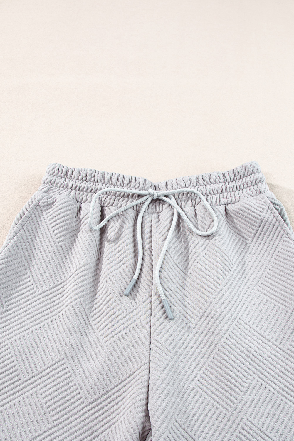 Elevate your style with this Women's Light Grey Solid Textured Collared V-Neck Top and Wide Leg Pants Set. The two-piece set provides a sleek and versatile ensemble, perfect for daily wear and casual occasions. The textured fabric adds depth and interest to the outfit, while the V-neck top offers a flattering and stylish neckline. The wide-leg pants provide a chic and comfortable bottom option, completing the perfect combo of chic and casual. Made from premium 95% polyester and 5% elastane, this set ensures a comfortable fit and durability. The light grey color and solid pattern make it easy to mix and match with other pieces in your wardrobe. This set is the epitome of effortless style and comfort, making it a must-have addition to your collection. - Detail View 14 Elevate your style with this Women's Light Grey Solid Textured Collared V-Neck Top and Wide Leg Pants Set. The two-piece set provides a sleek and versatile ensemble, perfect for daily wear and casual occasions. The textured fabric adds depth and interest to the outfit, while the V-neck top offers a flattering and stylish neckline. The wide-leg pants provide a chic and comfortable bottom option, completing the perfect combo of chic and casual. Made from premium 95% polyester and 5% elastane, this set ensures a comfortable fit and durability. The light grey color and solid pattern make it easy to mix and match with other pieces in your wardrobe. This set is the epitome of effortless style and comfort, making it a must-have addition to your collection. - Detail View 14