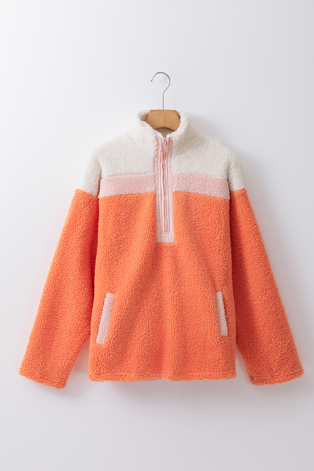 Stay warm and stylish this winter with our Orange Colorblock Half Zipper Stand Neck Sherpa Sweatshirt. The sherpa-trimmed exterior adds a plush and cozy touch, while the color block design creates a fashionable contrast. The half zipper design allows for adjustable warmth, and the stand neck provides extra coverage and a sleek silhouette. Pair this sweatshirt with your favorite jeans or leggings for a cozy and comfortable look. Perfect for outdoor activities, daily wear, or just lounging around. Made from 100% polyester fleece, this sweatshirt is soft, breathable, and easy to care for. - Detail View 9 Stay warm and stylish this winter with our Orange Colorblock Half Zipper Stand Neck Sherpa Sweatshirt. The sherpa-trimmed exterior adds a plush and cozy touch, while the color block design creates a fashionable contrast. The half zipper design allows for adjustable warmth, and the stand neck provides extra coverage and a sleek silhouette. Pair this sweatshirt with your favorite jeans or leggings for a cozy and comfortable look. Perfect for outdoor activities, daily wear, or just lounging around. Made from 100% polyester fleece, this sweatshirt is soft, breathable, and easy to care for. - Detail View 9