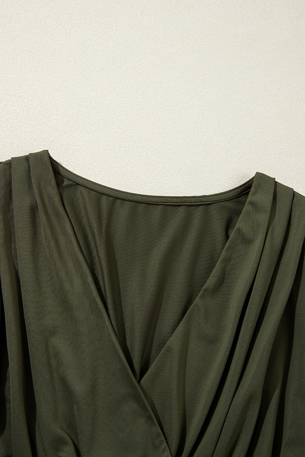 Elevate your style with this sophisticated Women's Moss Green Ruched Wrap V Neck Long Sleeve Bodysuit. Featuring a classic silhouette with a wrapped V neck and long sleeves, this bodysuit exudes elegance and sophistication. The ruched detailing adds a touch of texture and refinement, making it perfect for daily or formal occasions. Pair it with high-waist trousers or a skirt for a polished and put-together ensemble. The sleek and fitted design ensures a comfortable fit, making it a must-have addition to your wardrobe. - Detail View 9 Elevate your style with this sophisticated Women's Moss Green Ruched Wrap V Neck Long Sleeve Bodysuit. Featuring a classic silhouette with a wrapped V neck and long sleeves, this bodysuit exudes elegance and sophistication. The ruched detailing adds a touch of texture and refinement, making it perfect for daily or formal occasions. Pair it with high-waist trousers or a skirt for a polished and put-together ensemble. The sleek and fitted design ensures a comfortable fit, making it a must-have addition to your wardrobe. - Detail View 9
