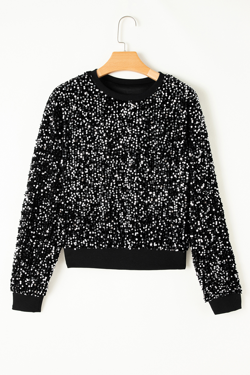 Make a statement with this stunning Women's Black Sequined Long Sleeve Crew Neck Cropped Blouse. The long sleeves and classic crew neck design provide a comfortable and timeless fit, while the trendy crop length adds a modern and chic twist to your outfit. The captivating sequins on the blouse elevate your casual look to a whole new level, perfect for night out, cocktail party or daily wear. This elegant blouse is made from premium 100% PET material, ensuring a soft and cozy fit. The combination of the black color and sequins makes it a versatile piece that can be paired with many different outfits and styles. - Detail View 9 Make a statement with this stunning Women's Black Sequined Long Sleeve Crew Neck Cropped Blouse. The long sleeves and classic crew neck design provide a comfortable and timeless fit, while the trendy crop length adds a modern and chic twist to your outfit. The captivating sequins on the blouse elevate your casual look to a whole new level, perfect for night out, cocktail party or daily wear. This elegant blouse is made from premium 100% PET material, ensuring a soft and cozy fit. The combination of the black color and sequins makes it a versatile piece that can be paired with many different outfits and styles. - Detail View 9