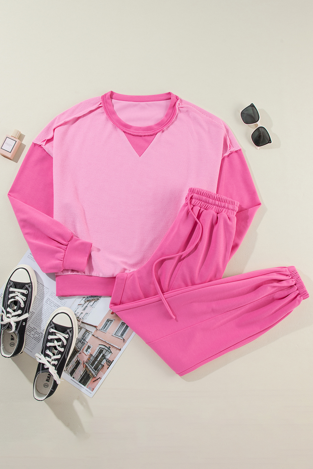 Elevate your casual style with this trendy Women's Bonbon Contrast Patchwork Pullover and Drawstring Joggers Set. The eye-catching colorblock design adds a modern and dynamic touch to the set, offering effortless matching and coordinated style. The pullover features a comfortable crew neck and long sleeves for a cozy feel, while the drawstring joggers ensure a customized and comfortable fit for all-day wear. Made from a blend of 65% polyester and 35% cotton, this set strikes the perfect balance between chic and casual. The high-waisted joggers and wide-leg silhouette provide a flattering and on-trend look. Perfect for daily wear, this two-piece set offers both style and comfort, making it a must-have addition to your wardrobe. - Detail View 4 Elevate your casual style with this trendy Women's Bonbon Contrast Patchwork Pullover and Drawstring Joggers Set. The eye-catching colorblock design adds a modern and dynamic touch to the set, offering effortless matching and coordinated style. The pullover features a comfortable crew neck and long sleeves for a cozy feel, while the drawstring joggers ensure a customized and comfortable fit for all-day wear. Made from a blend of 65% polyester and 35% cotton, this set strikes the perfect balance between chic and casual. The high-waisted joggers and wide-leg silhouette provide a flattering and on-trend look. Perfect for daily wear, this two-piece set offers both style and comfort, making it a must-have addition to your wardrobe. - Detail View 4